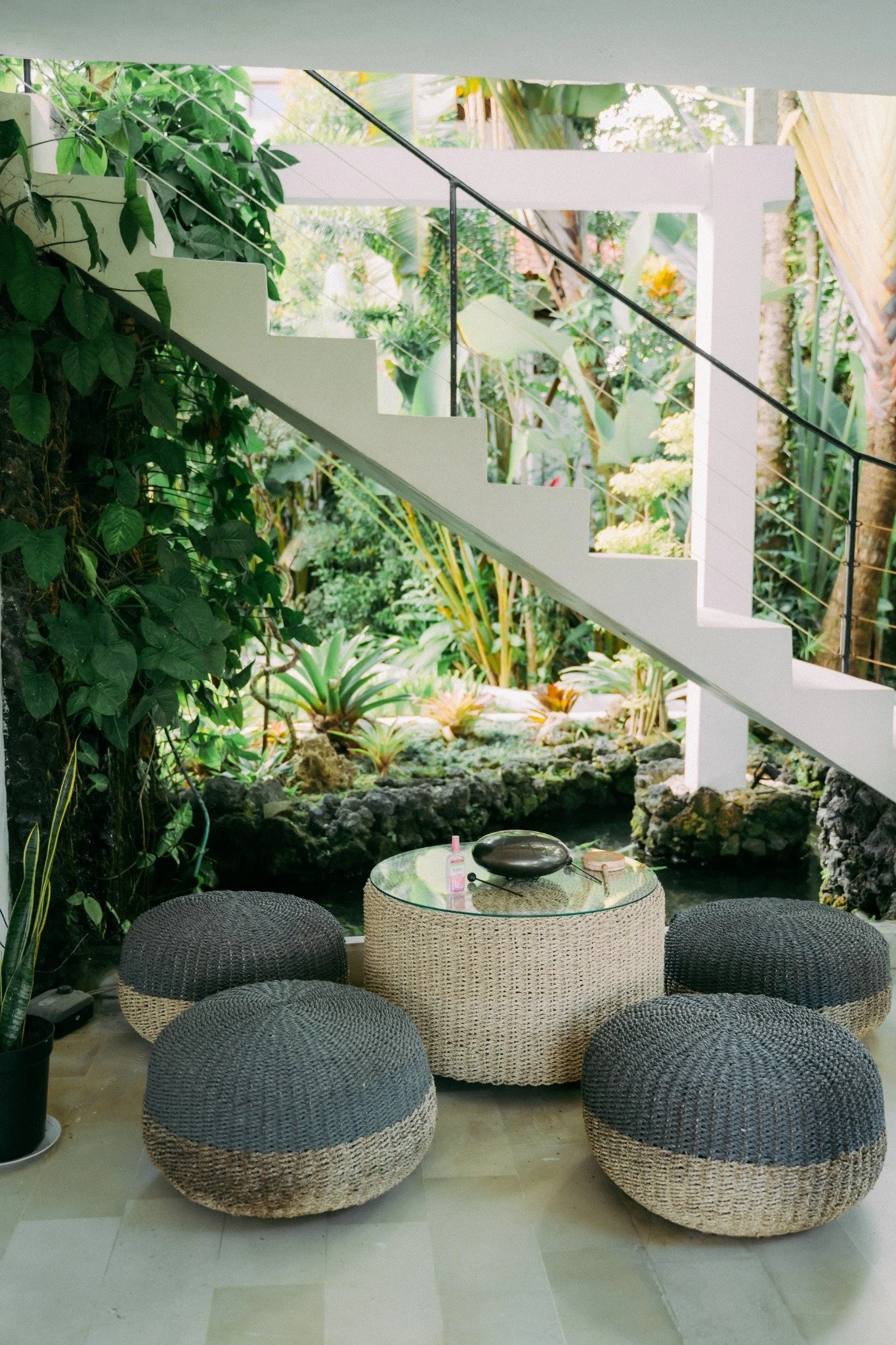 An intimate retreat gathering space opening onto a tropical garden