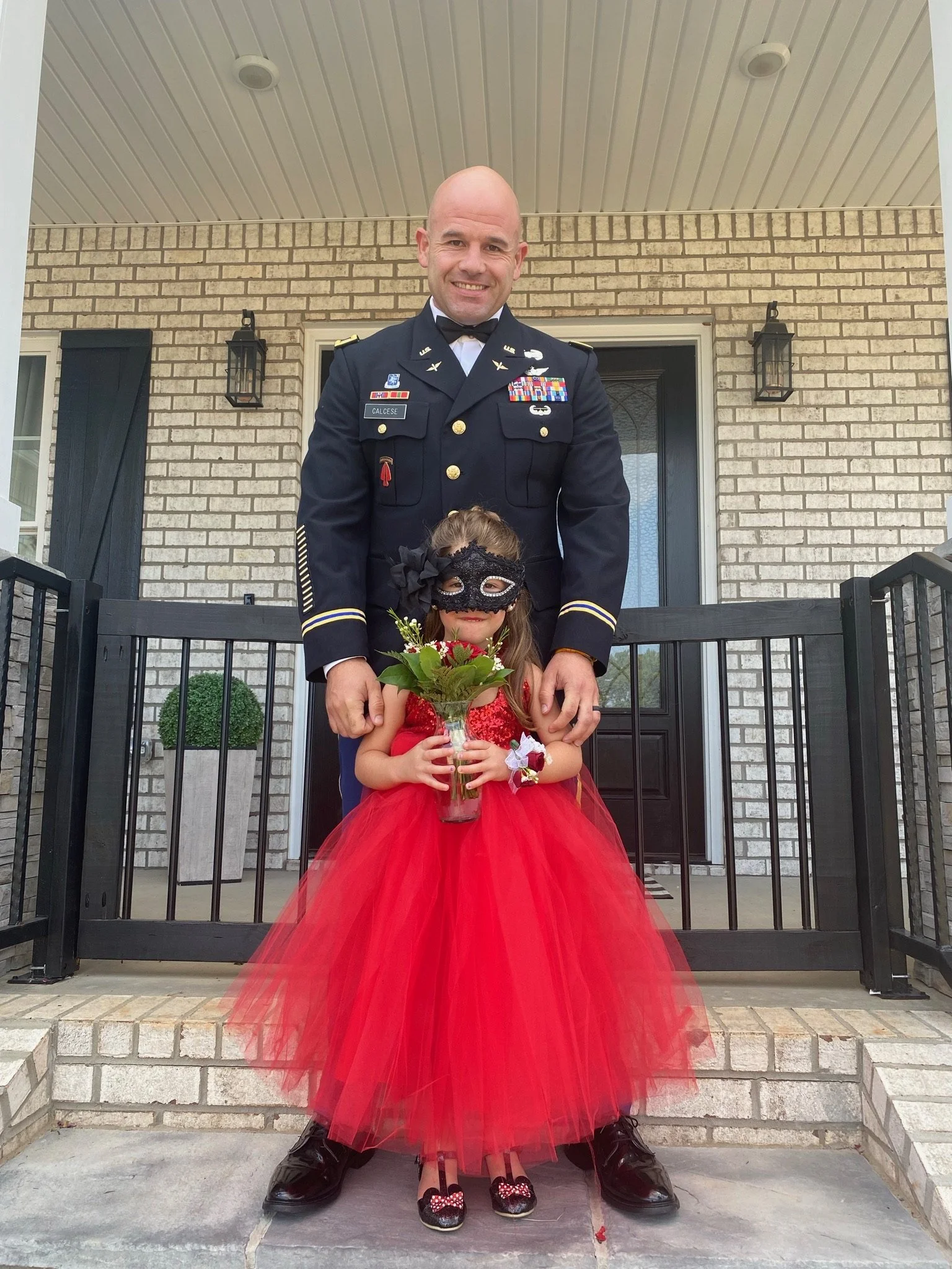 Phil Calcese in dress uniform with his daughter