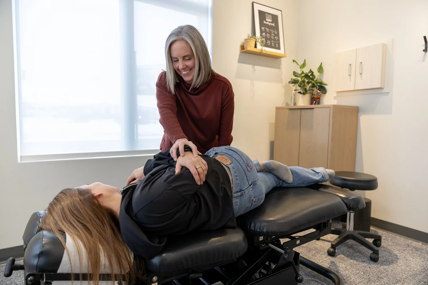 Chiropractor providing hands-on care in a treatment room