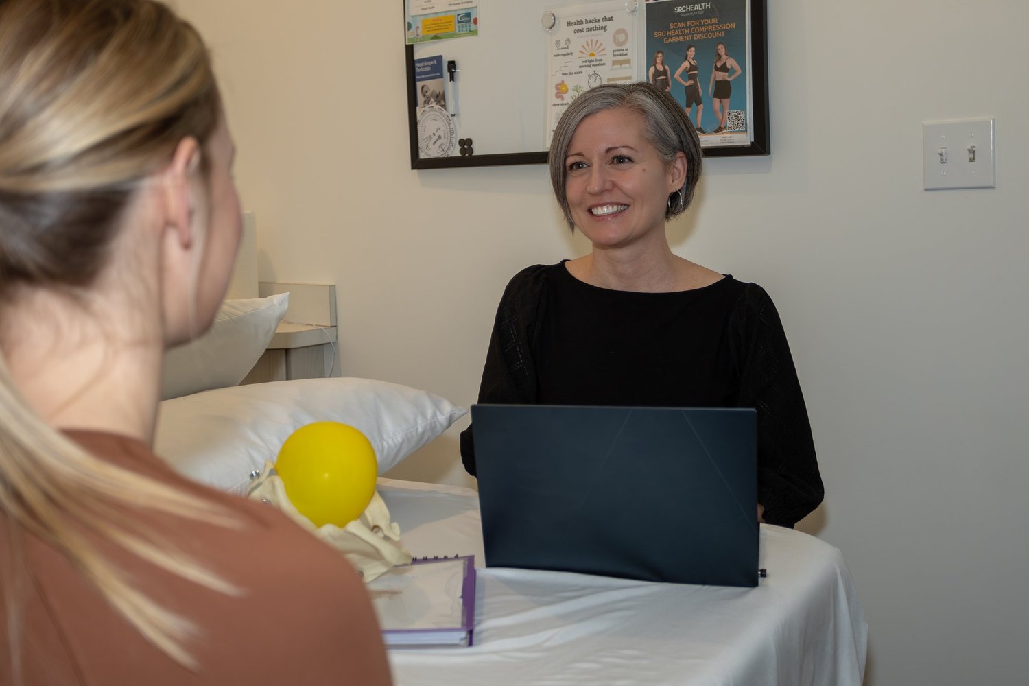 Physiotherapist listening to a patient in the treatment room