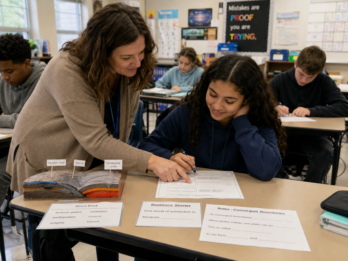 Teacher supporting a student with scaffolded science materials including a word bank and sentence starter