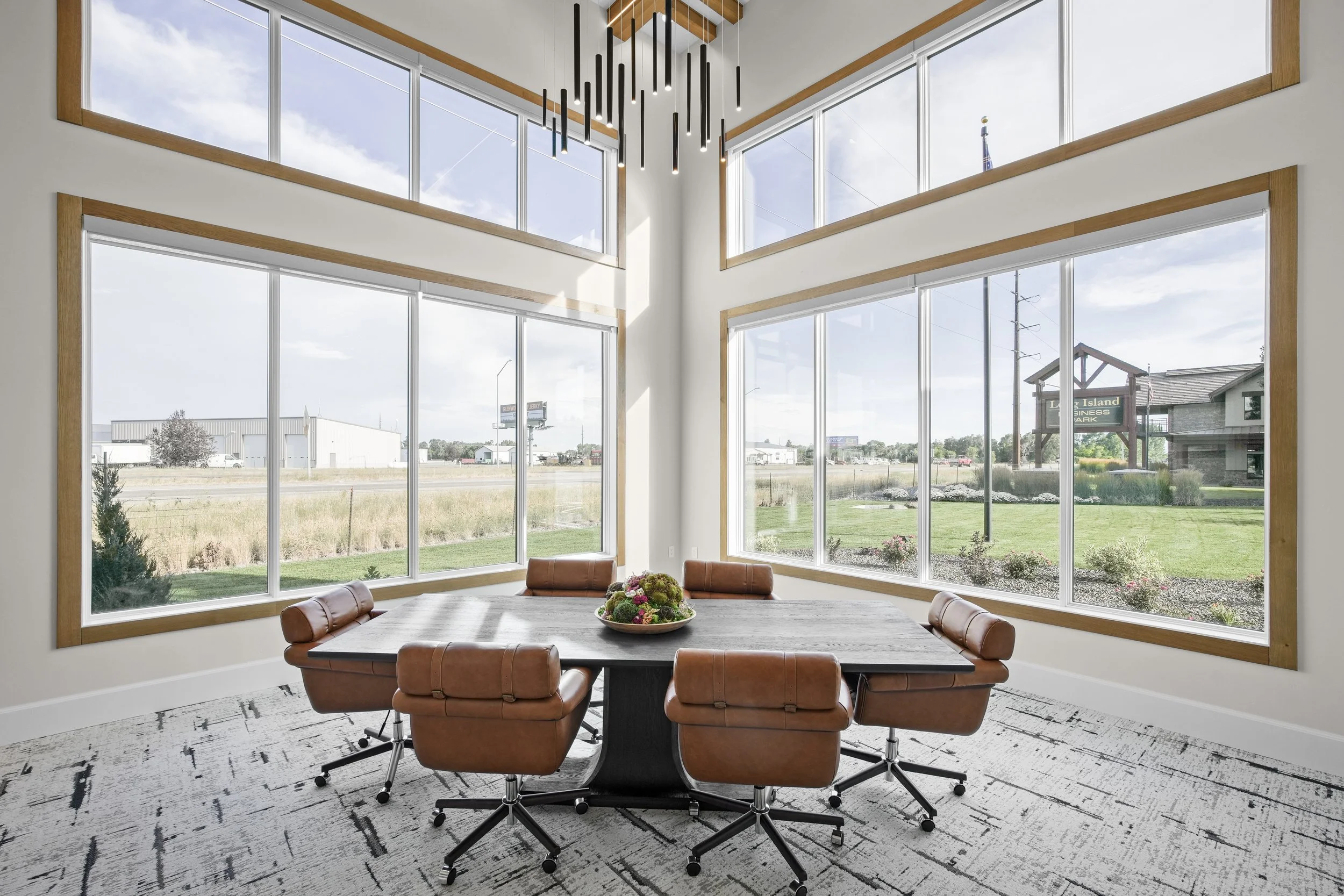 Sunlit conference room at the JAB office with a large meeting table and corner windows