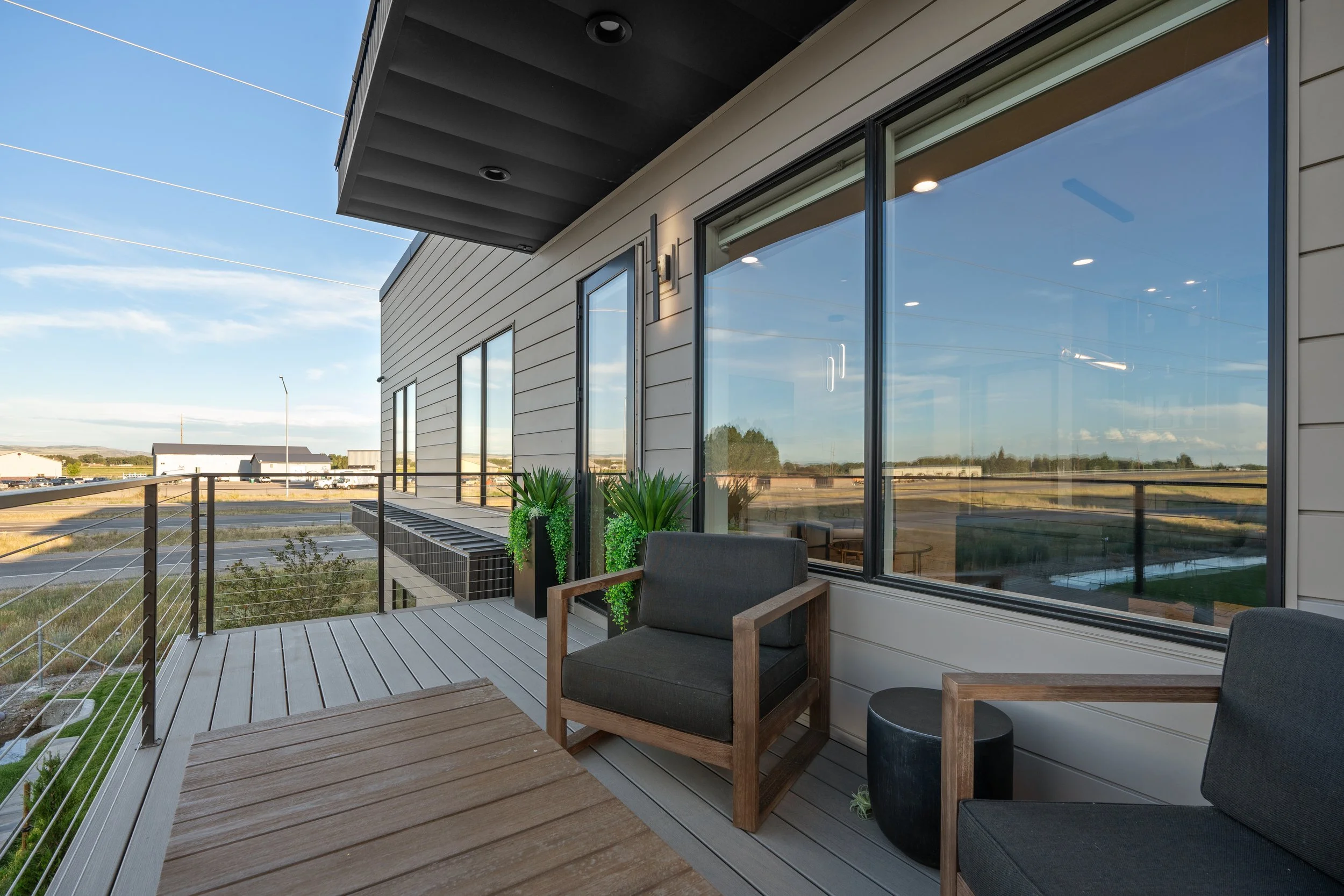 Upstairs terrace at the JAB office with outdoor seating and glass doors