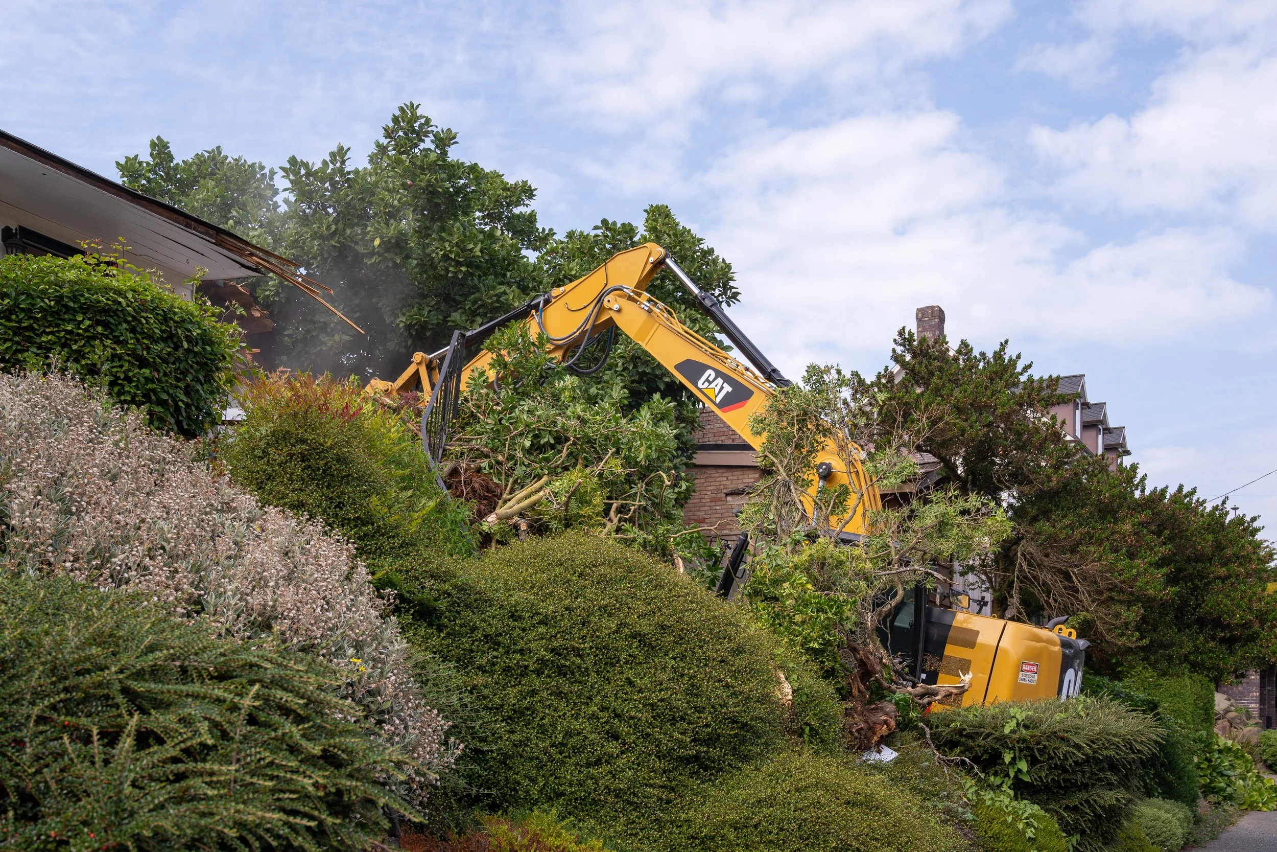 Structure demolition with debris box staged
