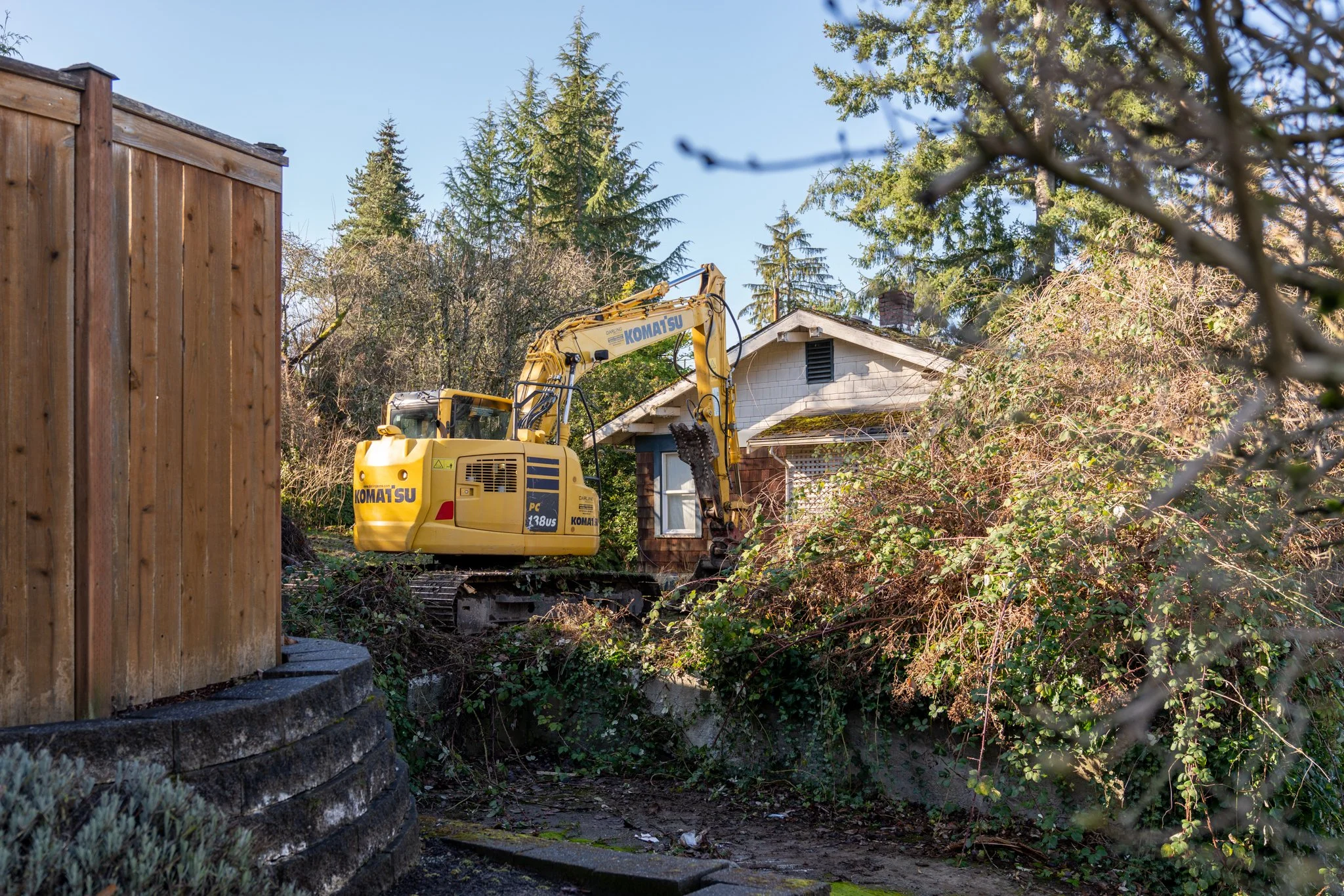 Komatsu working the rear of the structure