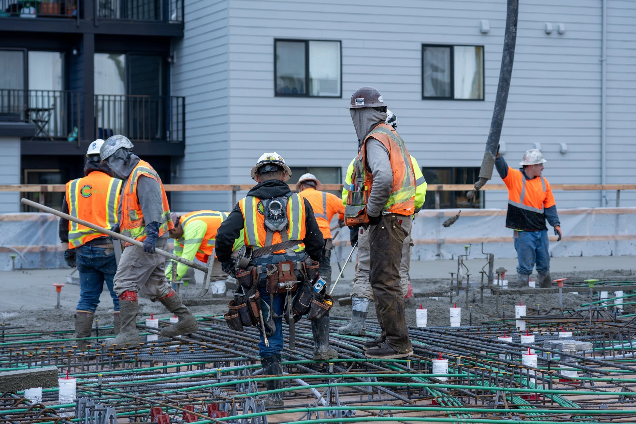 Crew placing concrete over the mat