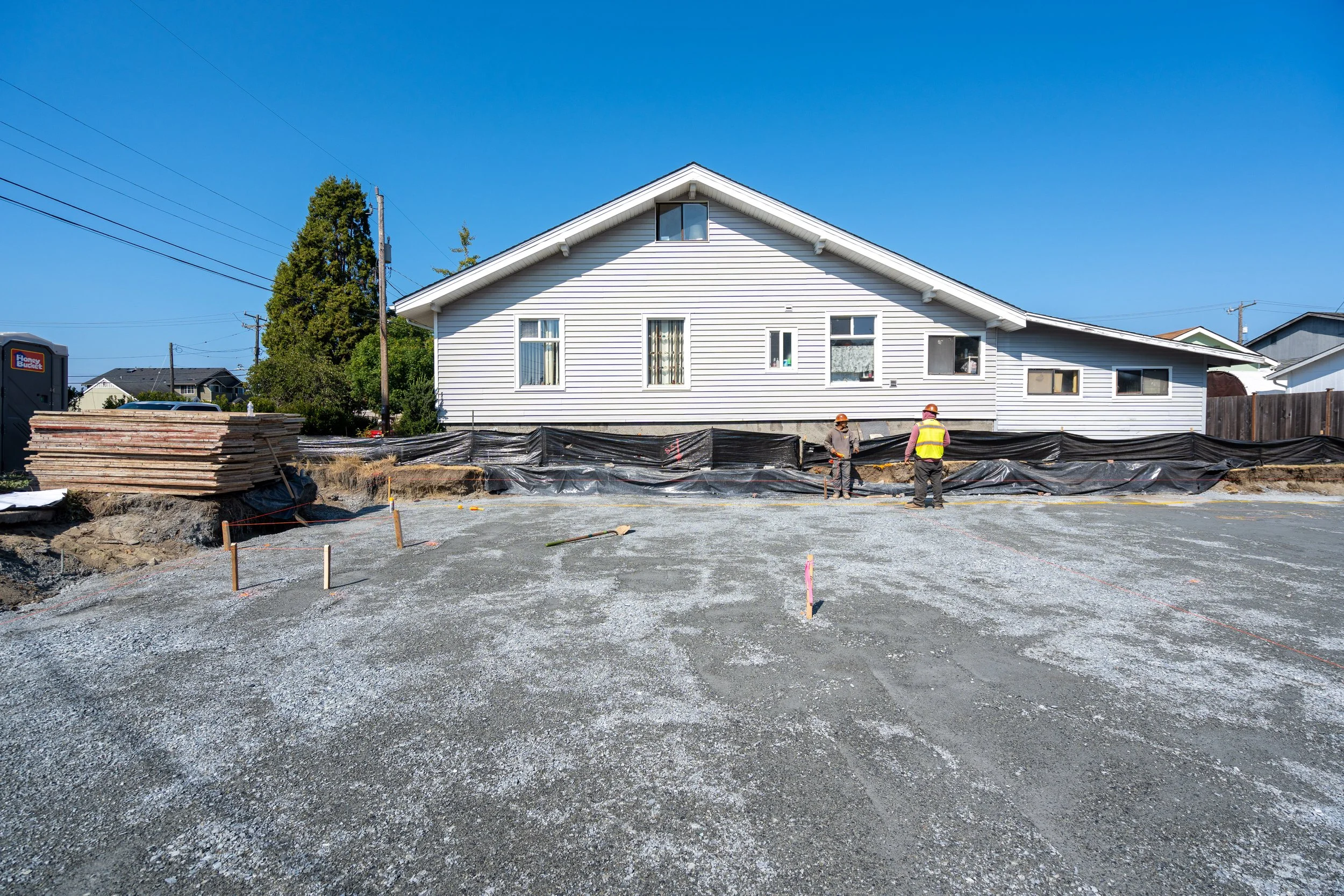 Graded pad held off the neighboring house