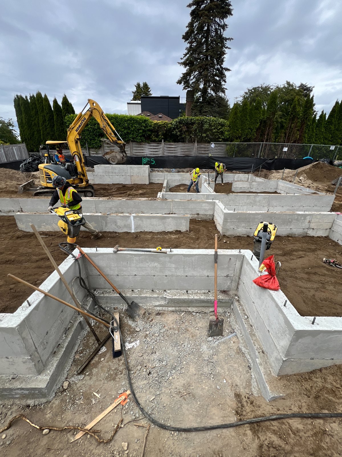 Backfill inside the three-home foundation layout