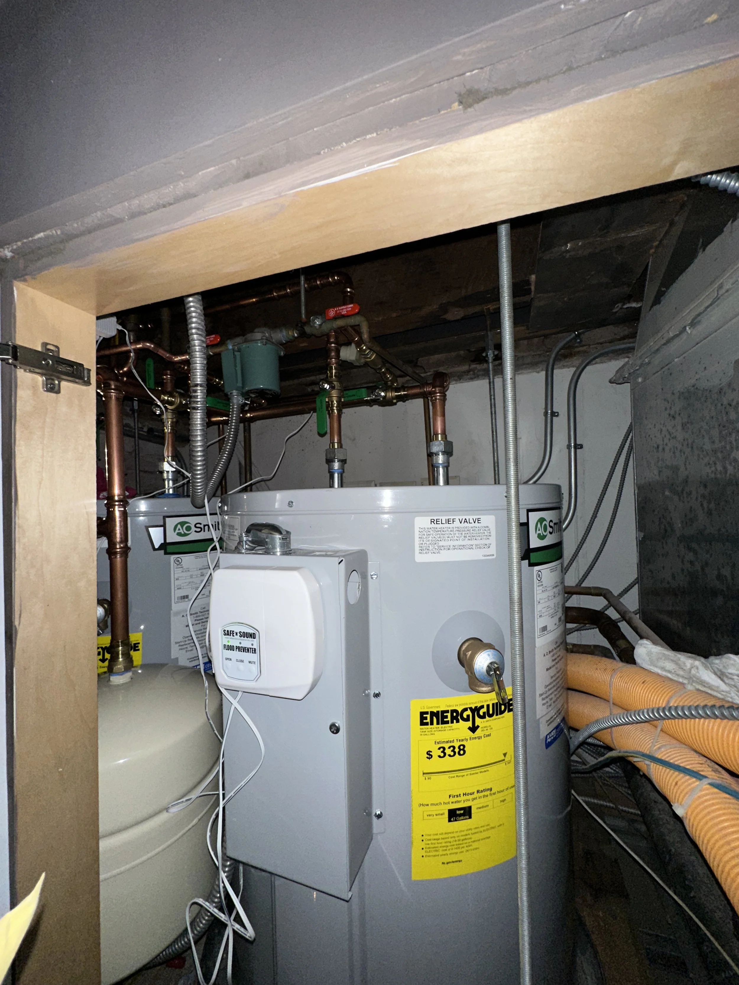 Water heater installation with copper piping and flood prevention equipment
