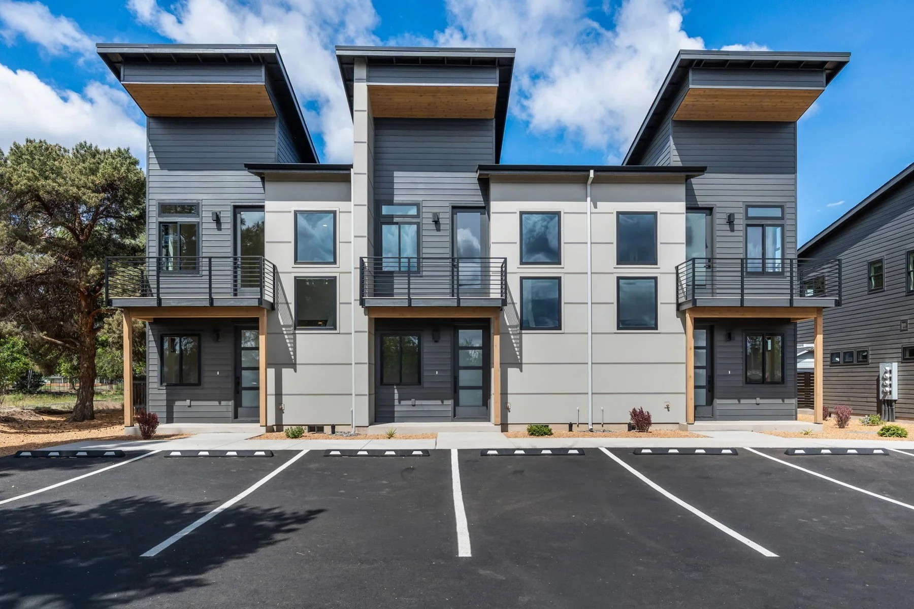 Yew Avenue, a modern multi-family townhome building in SW Redmond with shed roofs and private balconies