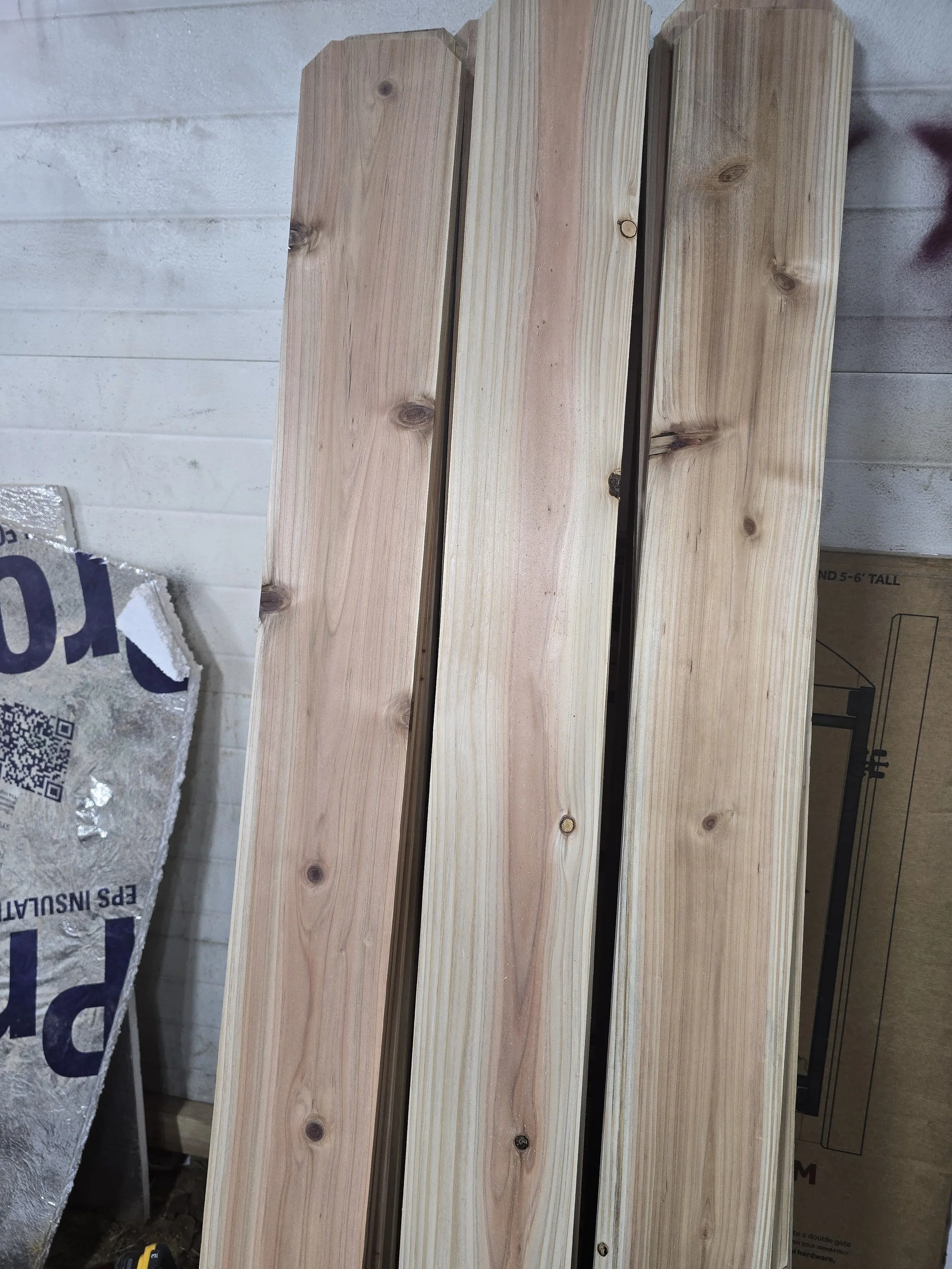 Cedar planks leaning against a wall
