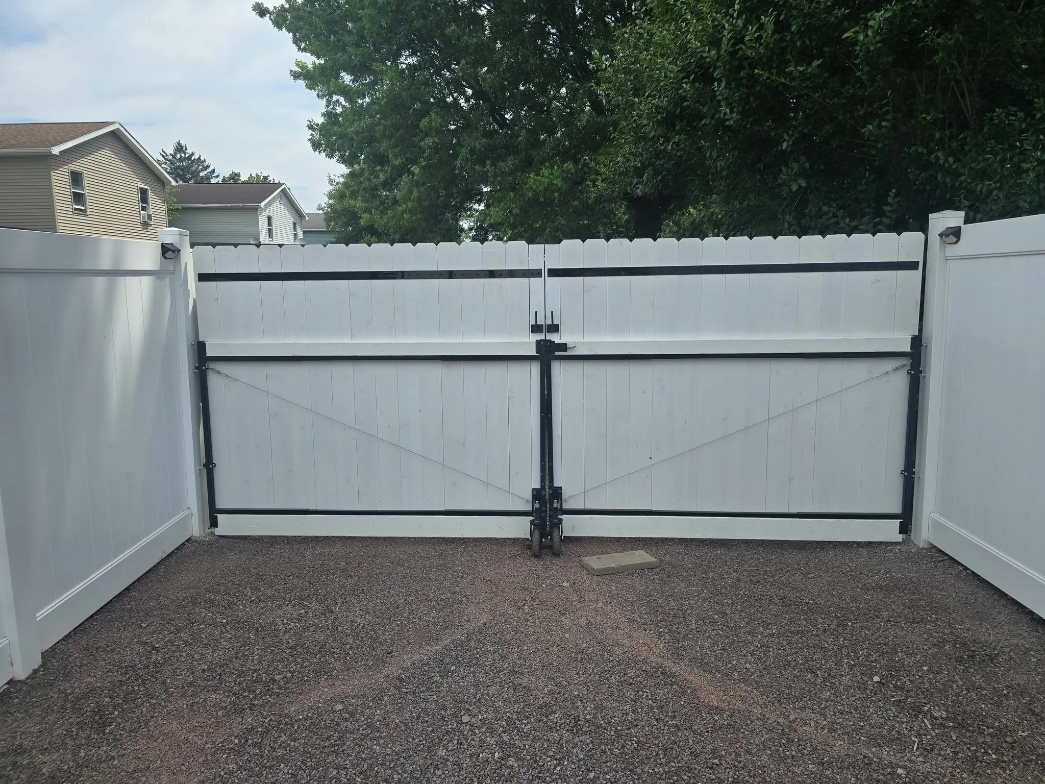 Inside of finished white double gate, showing dark frames and hardware