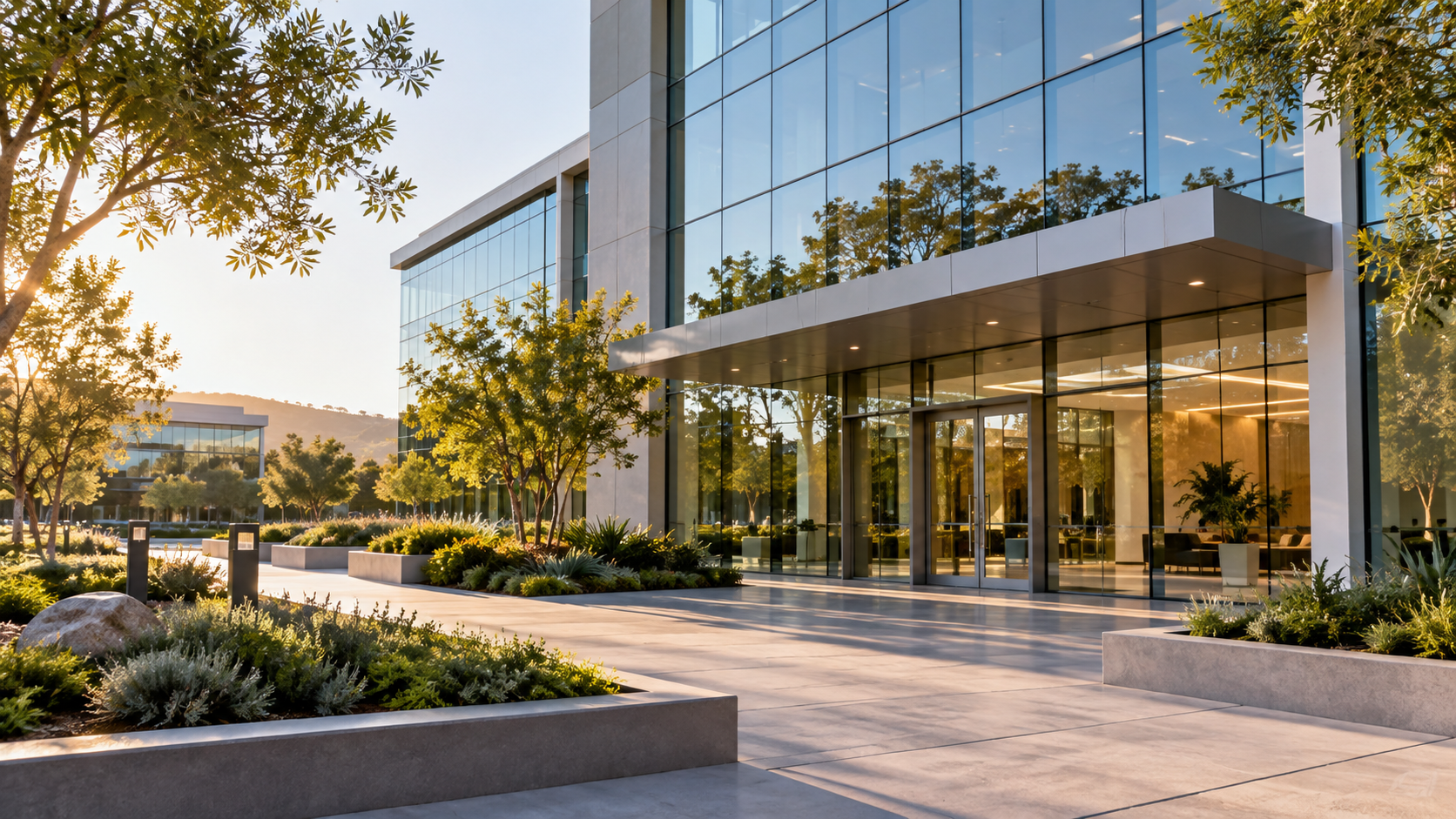 Modern office building with glass entrance and landscaped paths