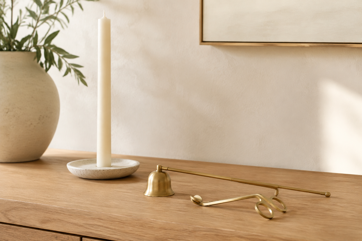 Styled illustration of a brushed-gold candle-care set