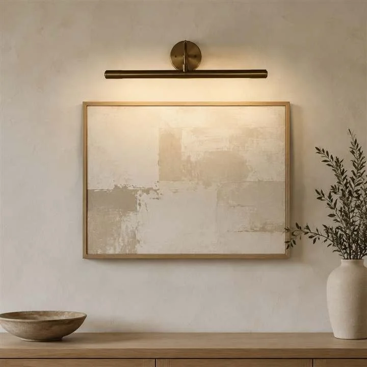 Antique brass picture light in a modern organic interior