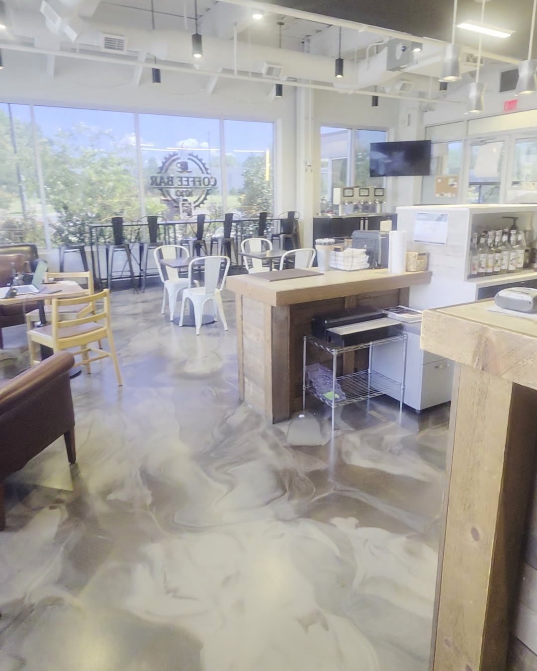 The bright Blackstone café with big windows, wood tables and white bistro chairs