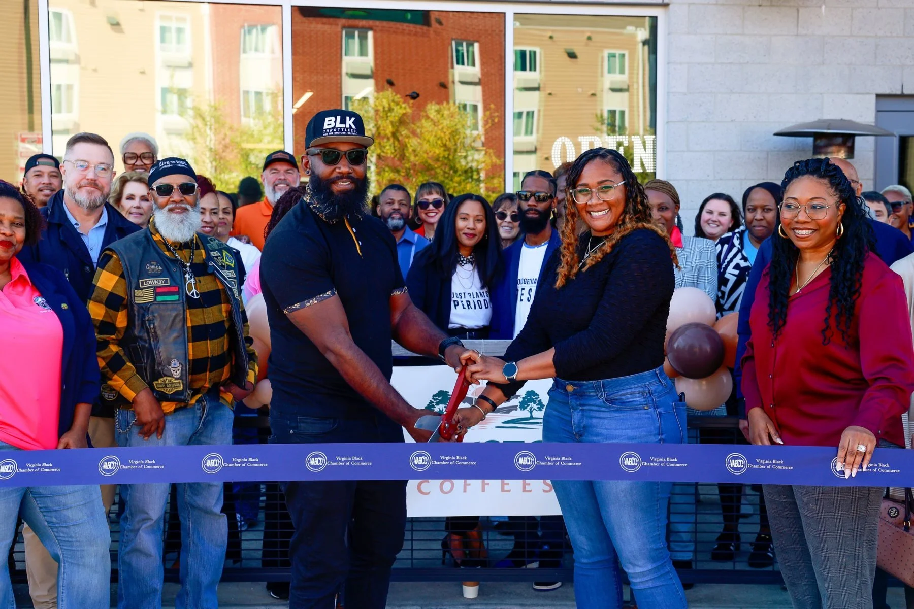 Kyle and Megan cutting the ribbon at the Blackstone Coffees grand opening with the Virginia Black Chamber of Commerce and the Stafford community