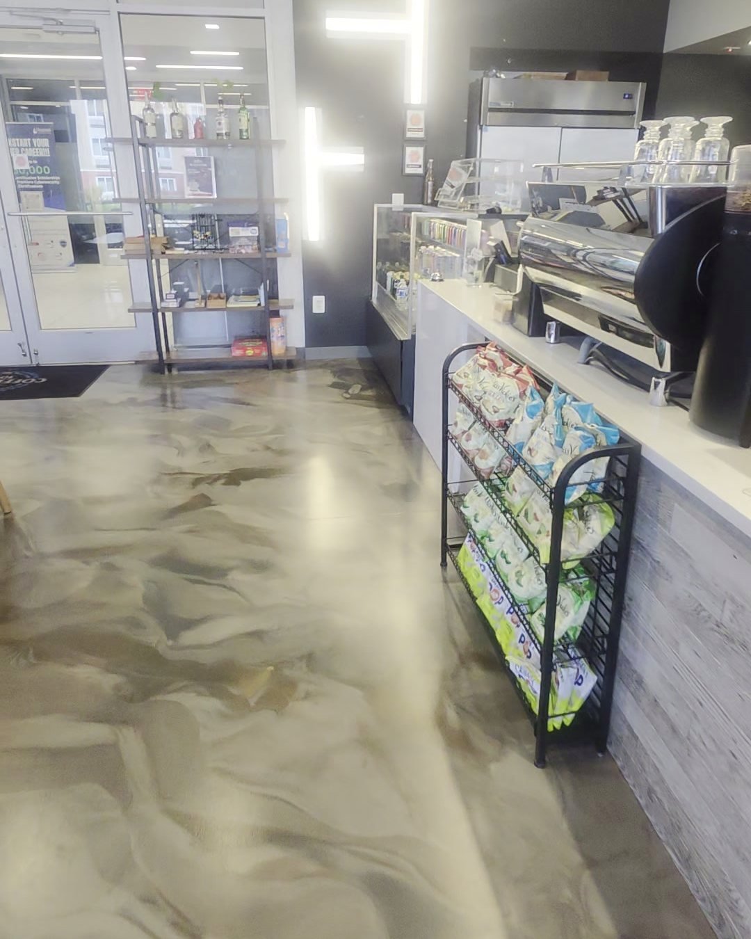 The coffee counter with espresso machine and pastry case
