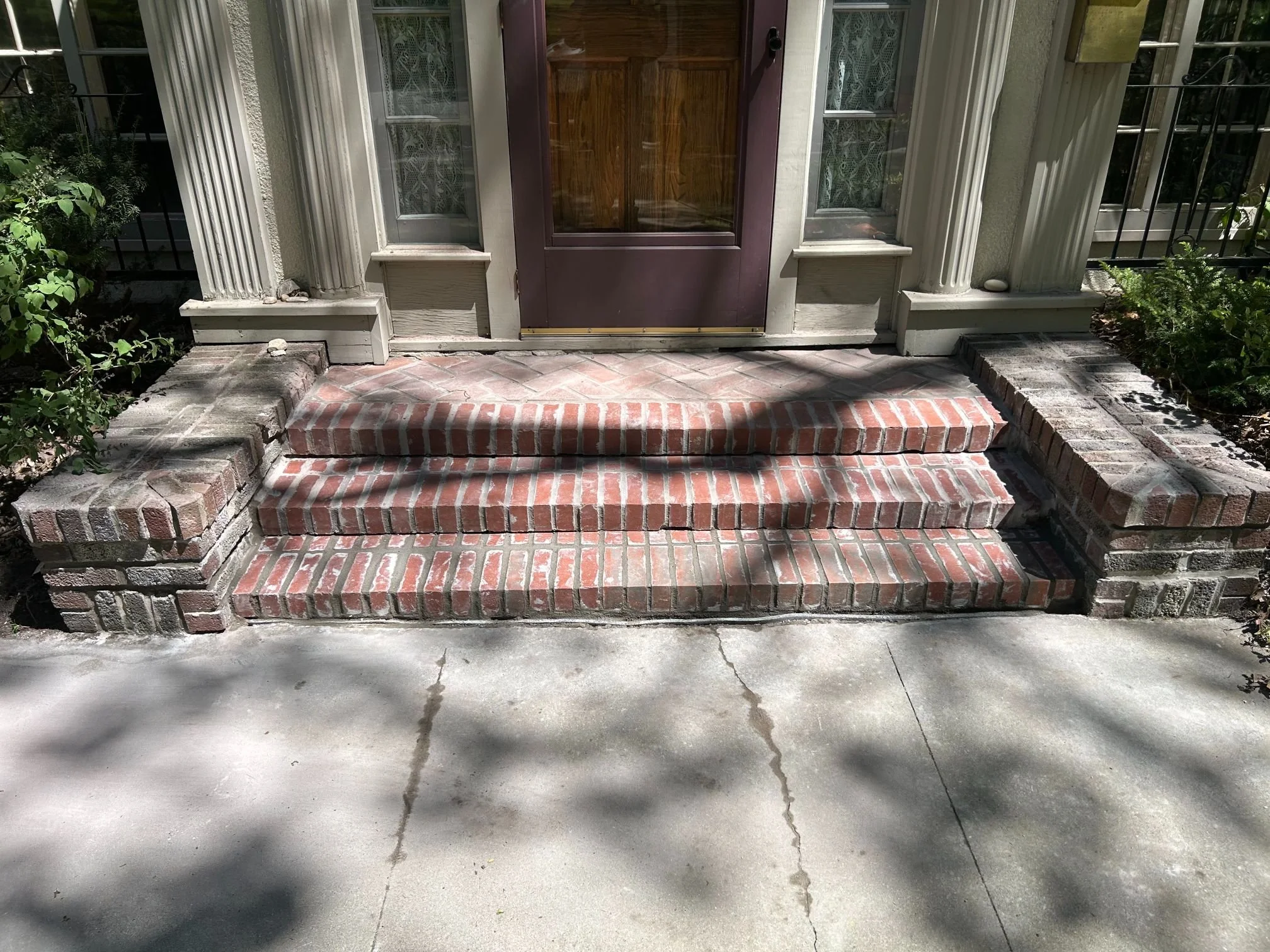 Brick steps, walkway and landing at the entrance of a home
