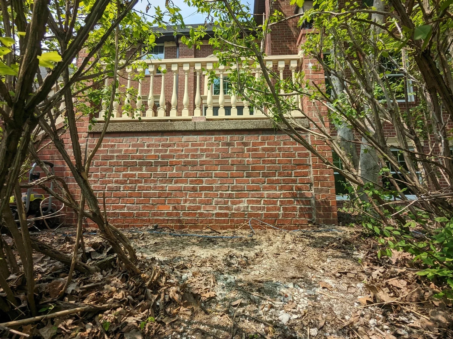 Exterior of a brick house with a stone balcony