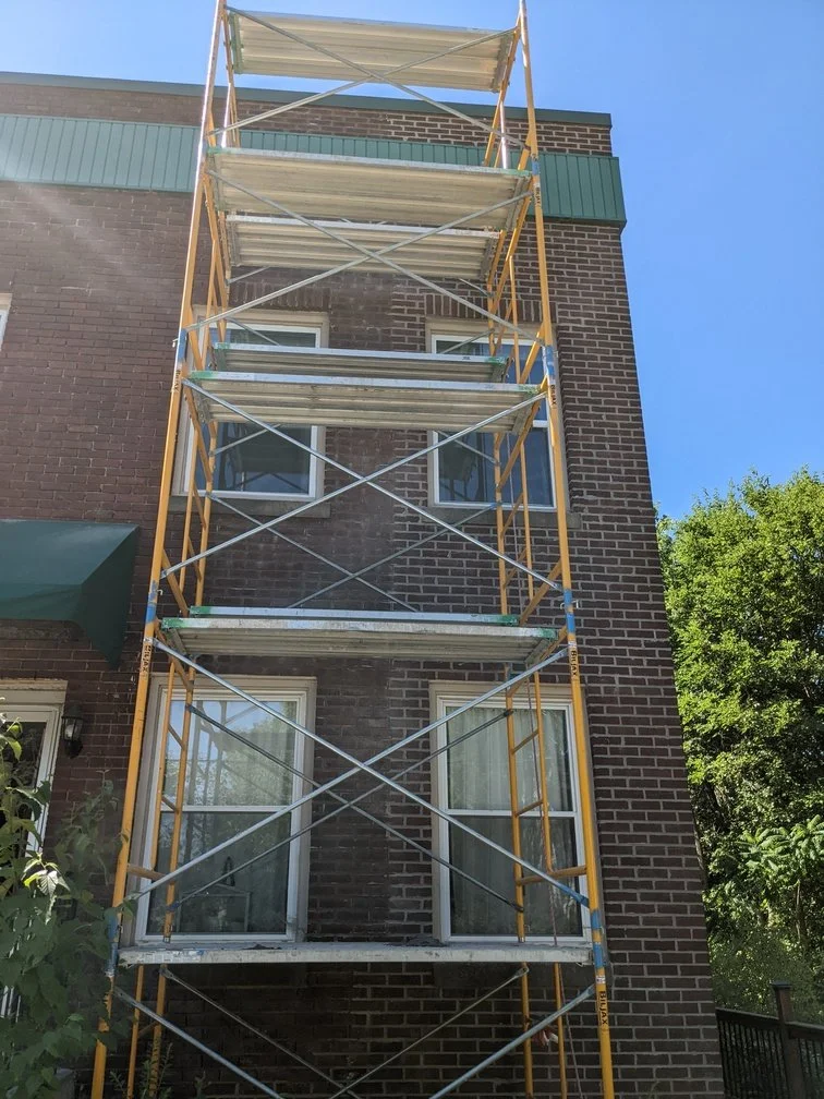 Mason repointing a brick wall in the Twin Cities