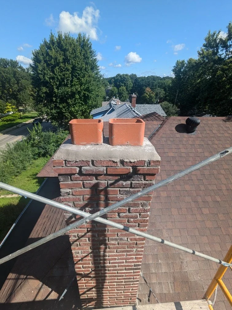 A brick wall with arched window lintels on a pre-1940 house