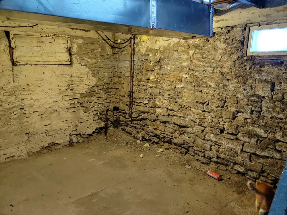Old stone foundation wall before repair