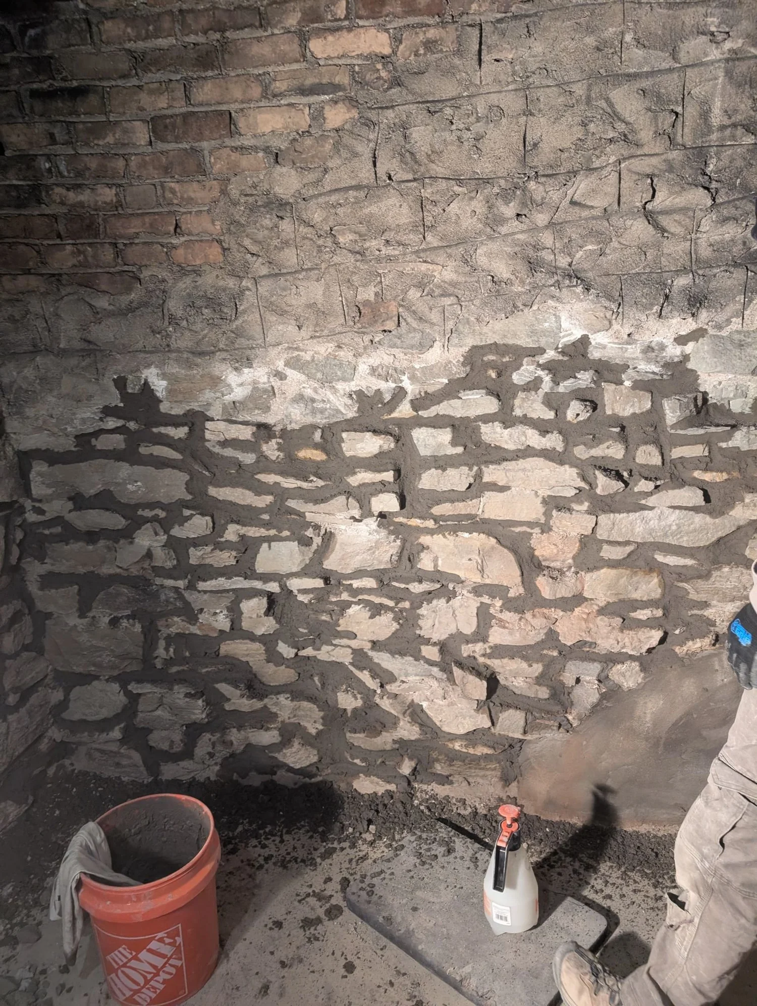 Mortar repair on a stone foundation wall
