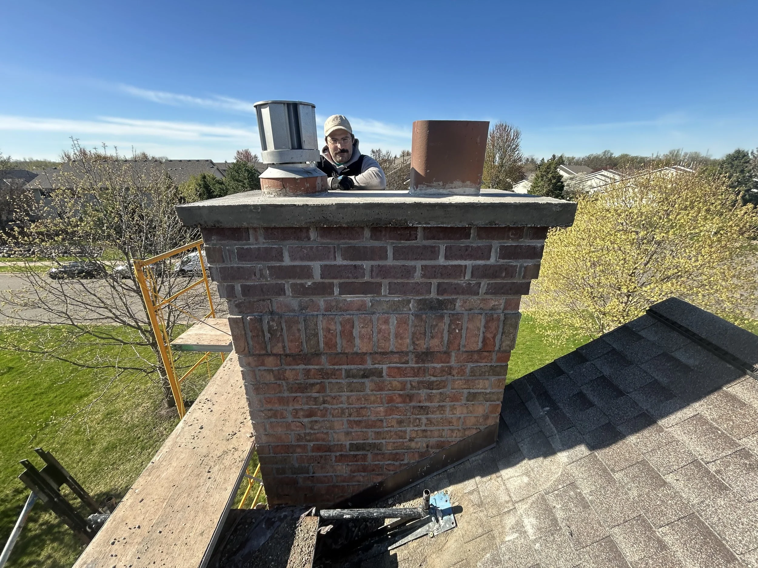 Rebuilt brick chimney with a new poured crown