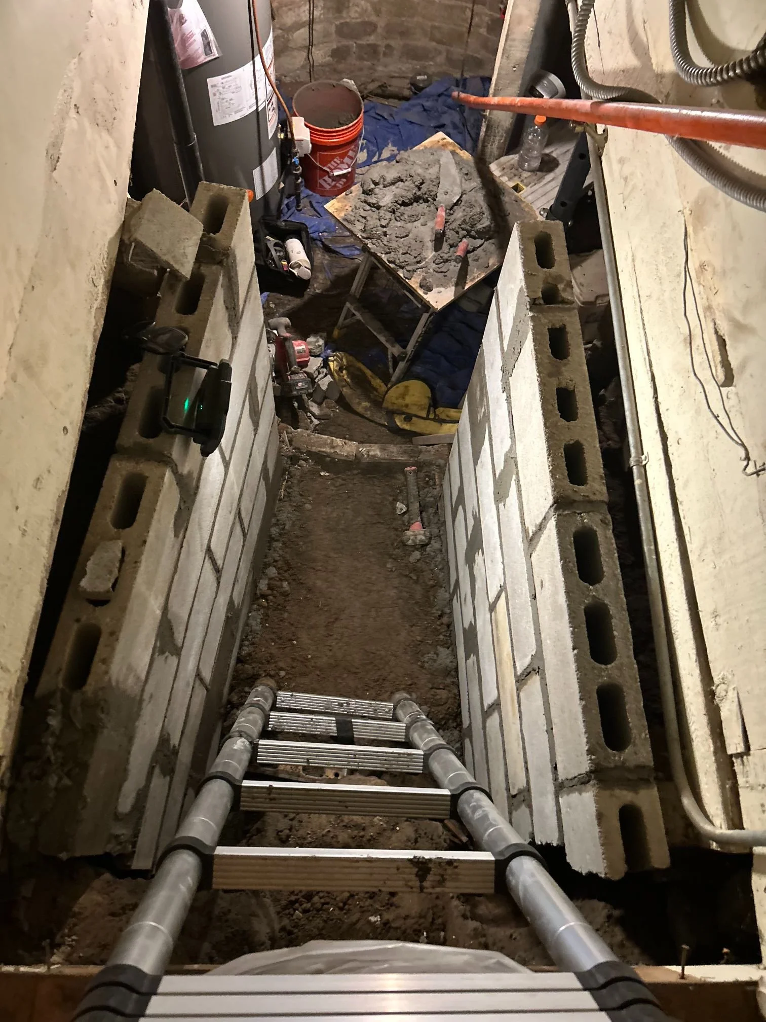 A mason grinding failed mortar out of the joints