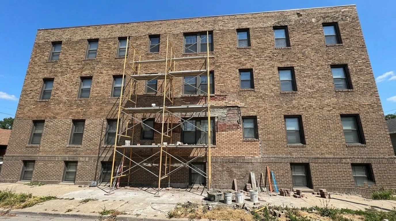 A commercial brick building with scaffolding in place