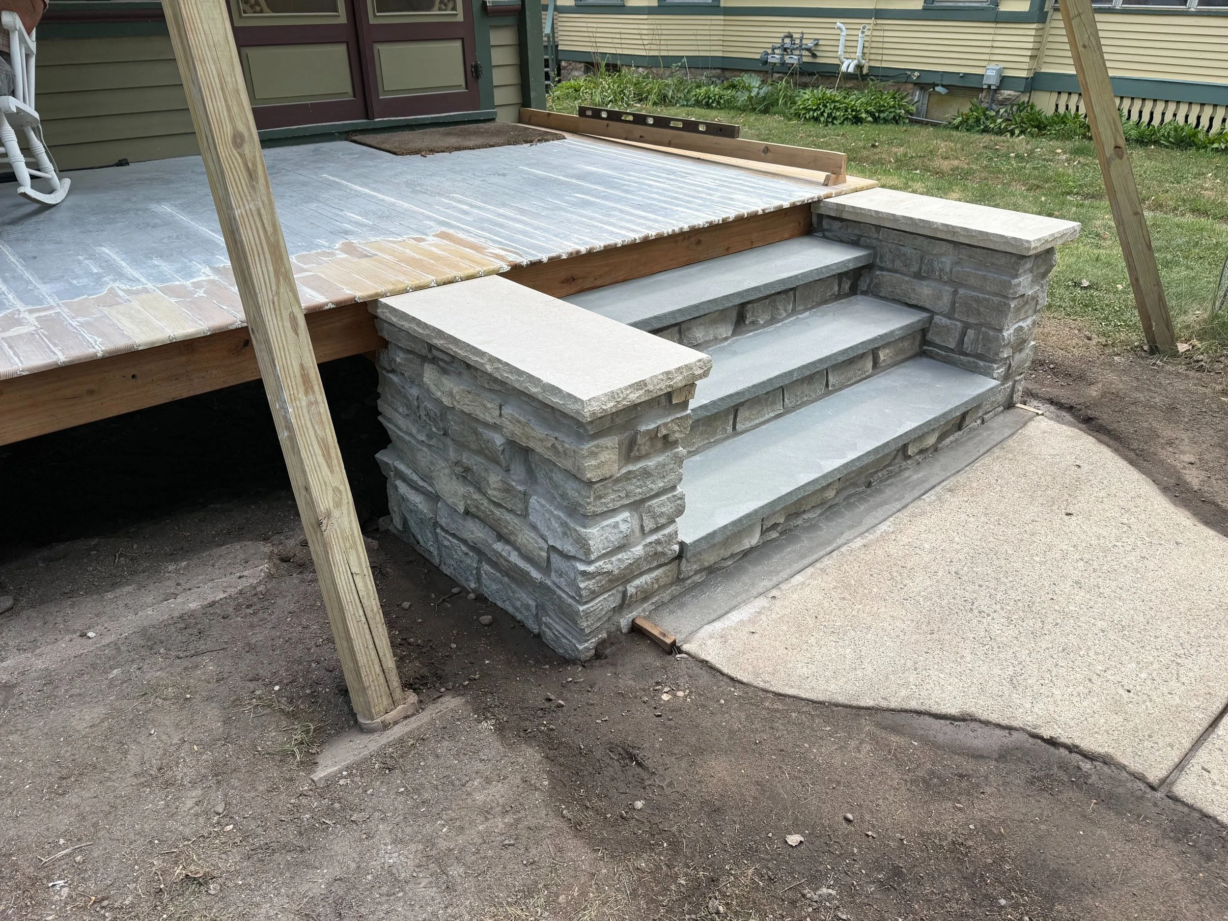 A new stone stoop and step with fresh stonework set on frost footings