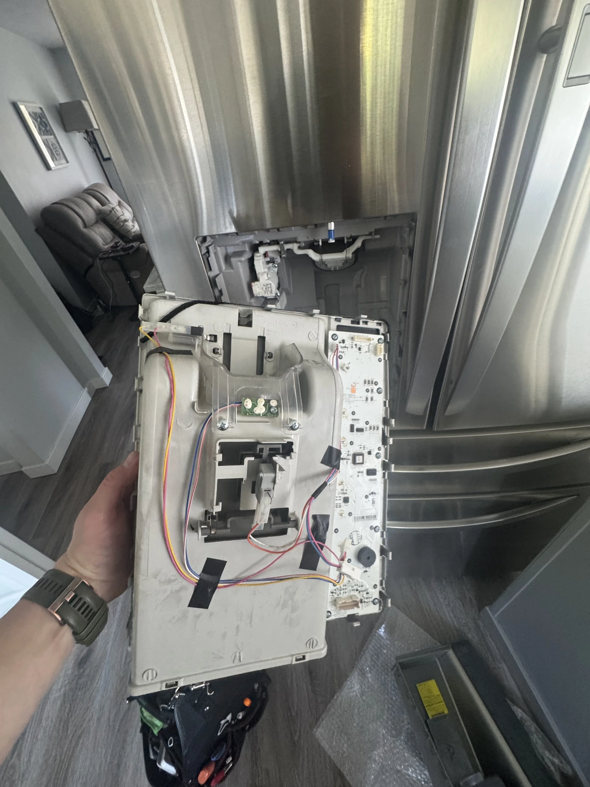 Refrigerator door panel with the dispenser mechanism exposed