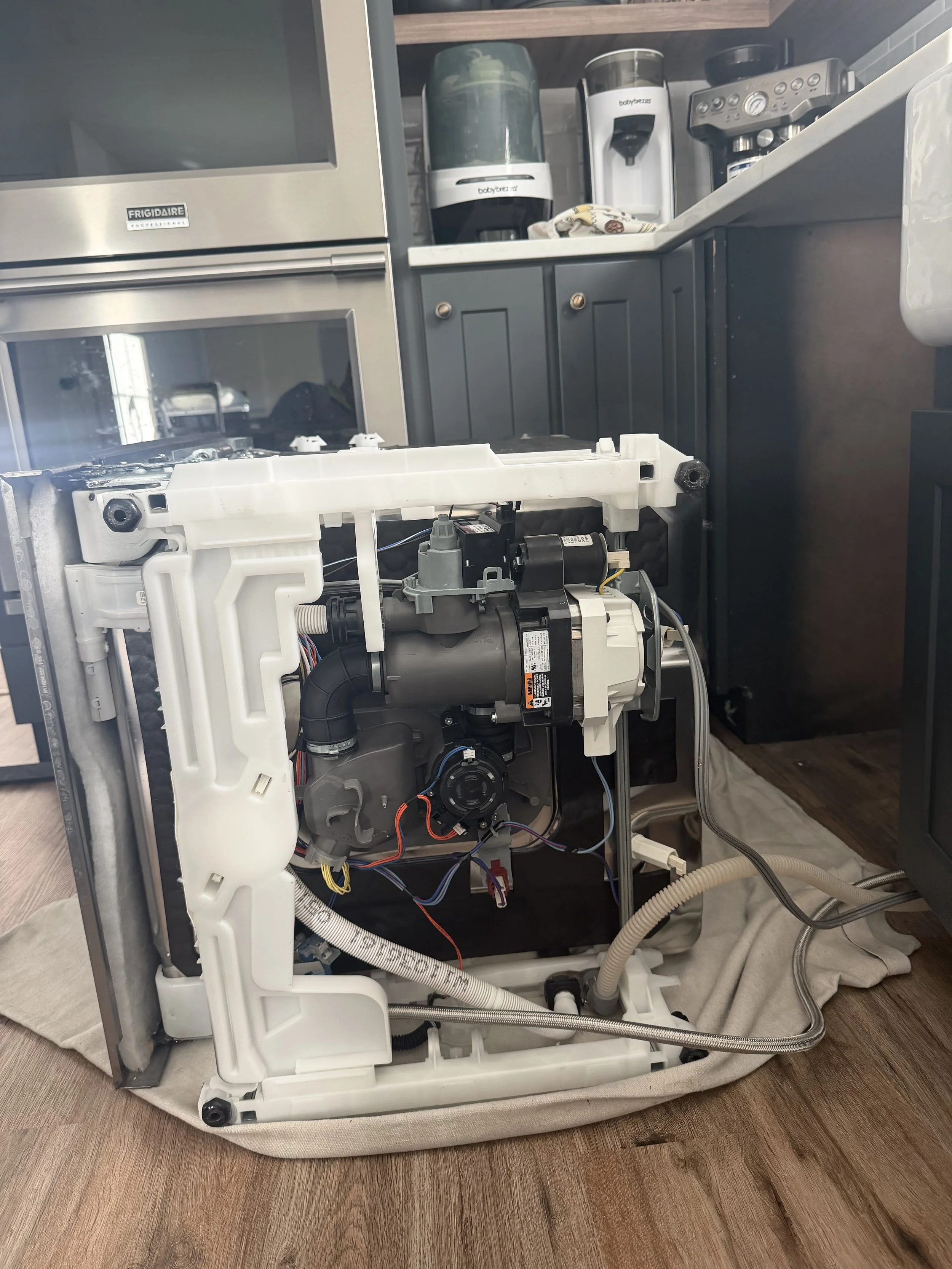 Dryer panel and motor housing during a Spokane dryer repair by SD Appliance