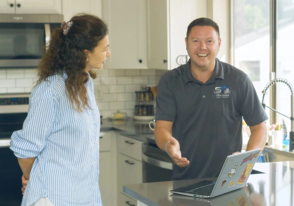 Sergei Dergunov greeting a homeowner at the door, arriving for a garbage disposal swap in Coeur d'Alene