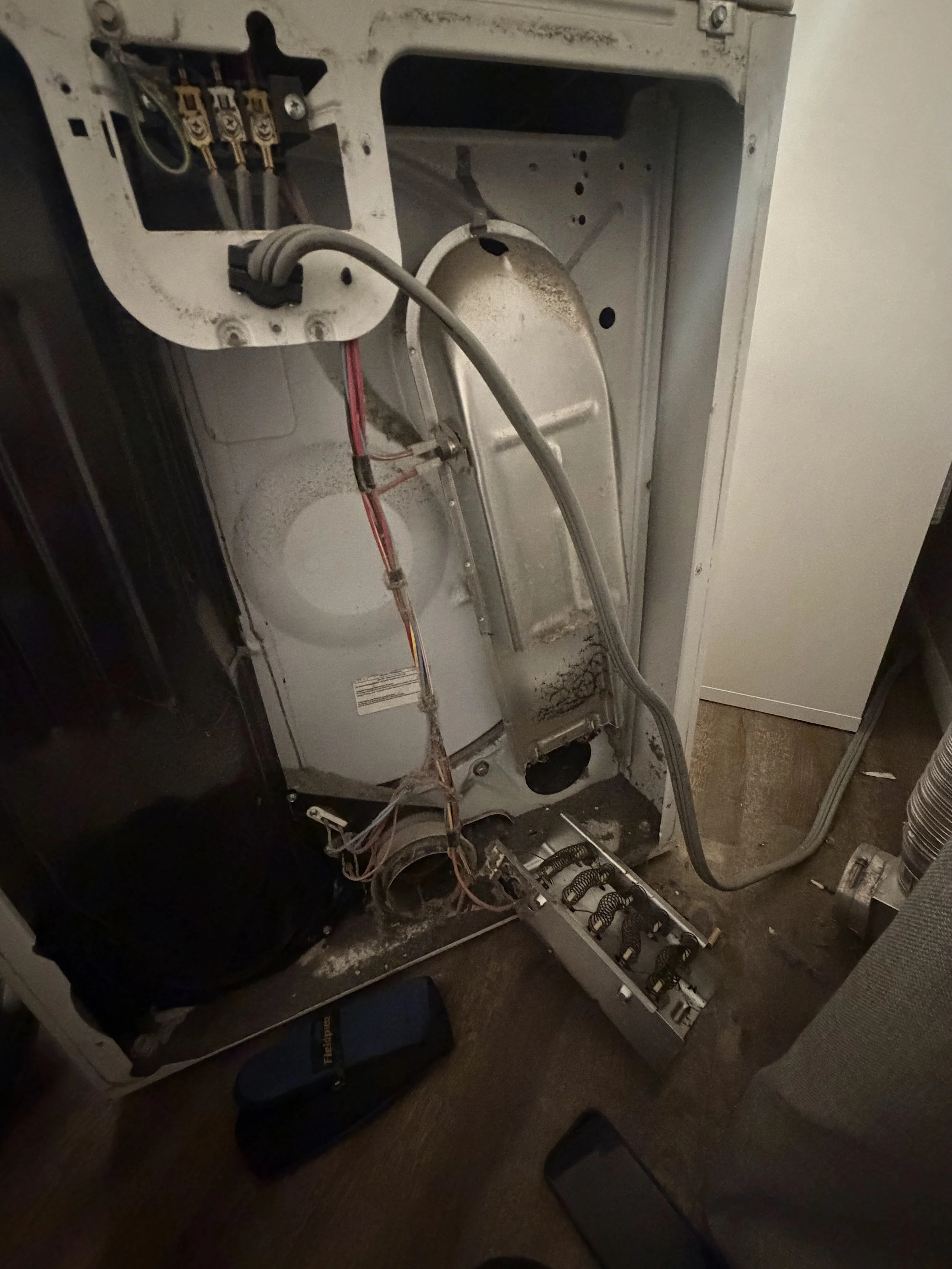 Refrigerator pulled out to reach the compressor area: refrigerator repair in a Post Falls home by SD Appliance