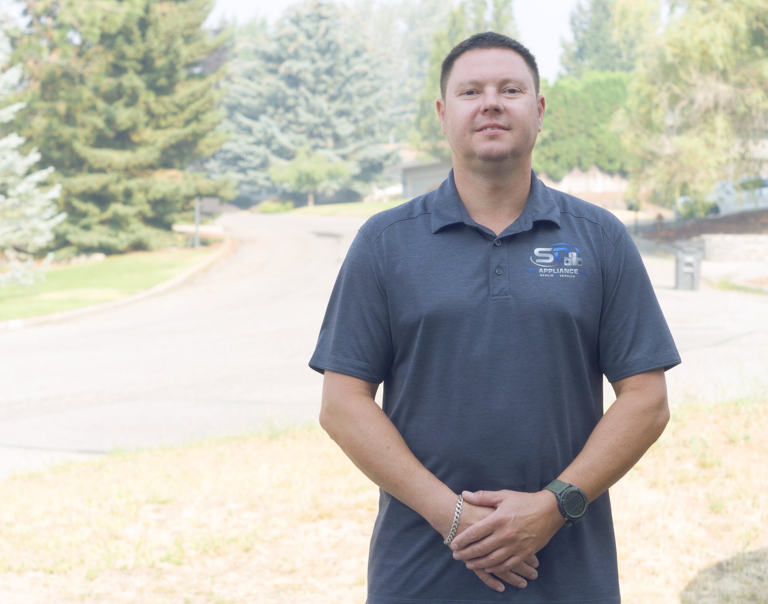 SD Appliance technician outdoors, ready for residential dryer repair in Post Falls homes