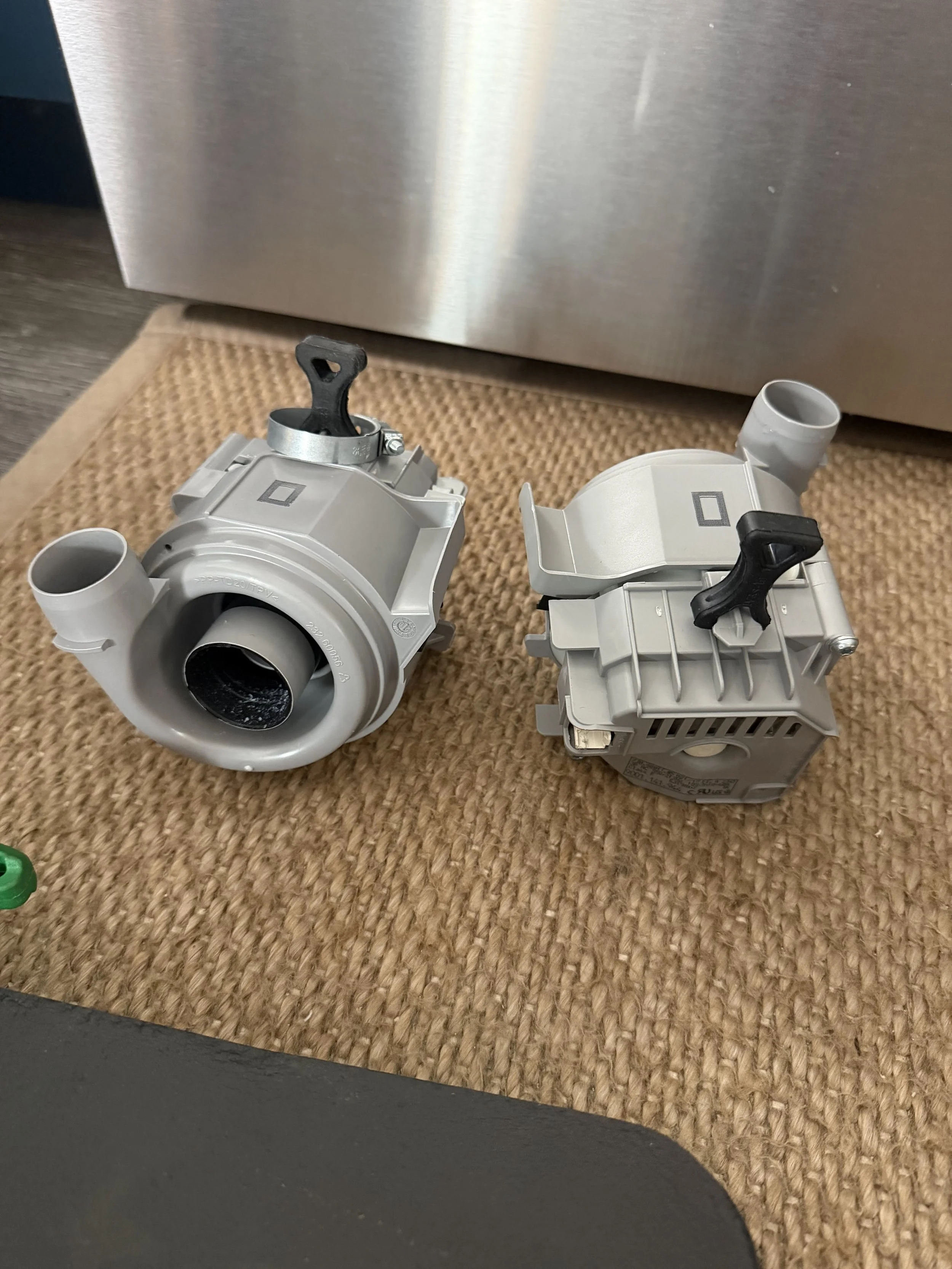 Two dishwasher pumps side by side during a Spokane dishwasher repair by SD Appliance