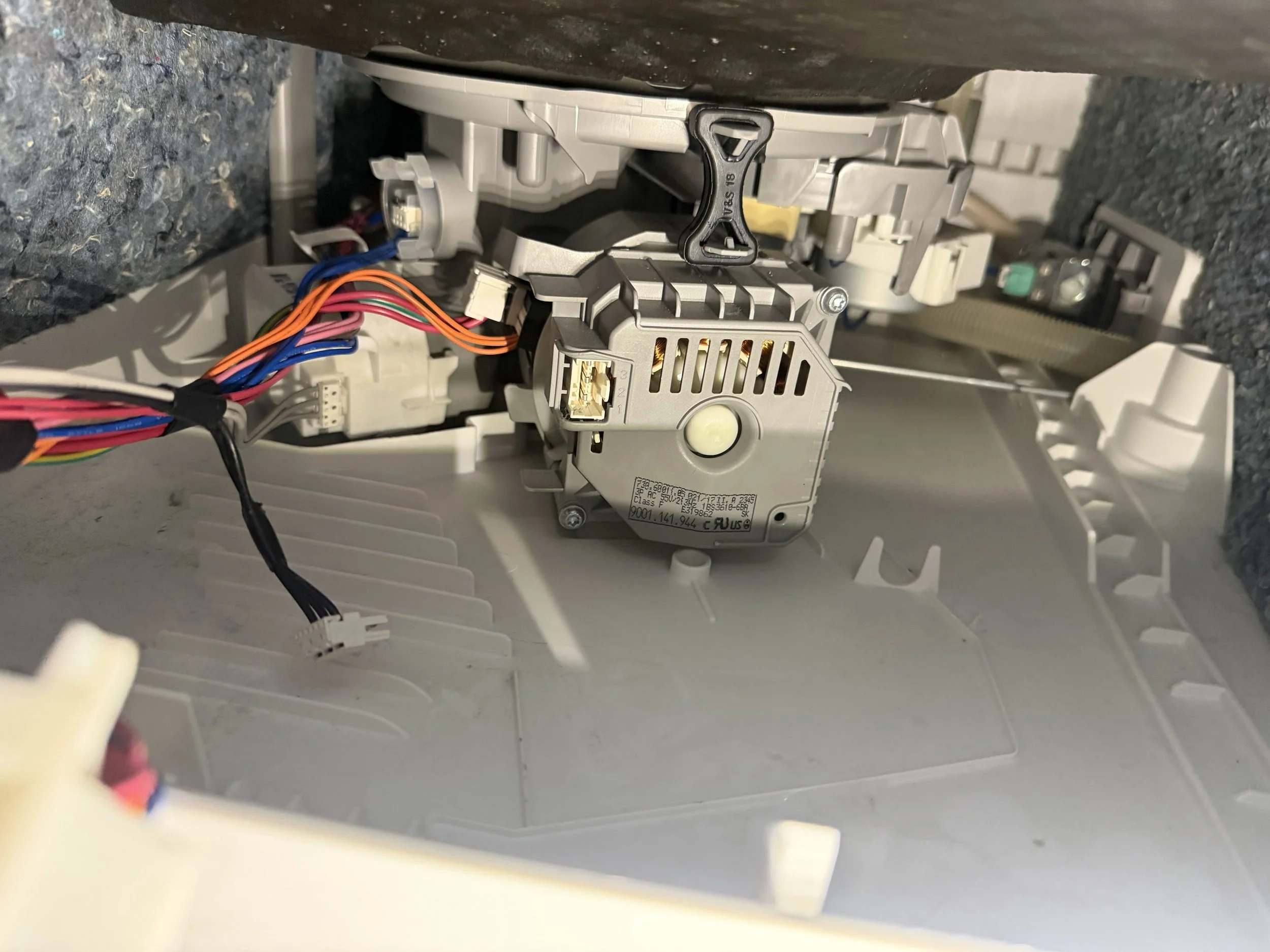 Appliance motor and wiring harness on the bench during a microwave repair in Spokane