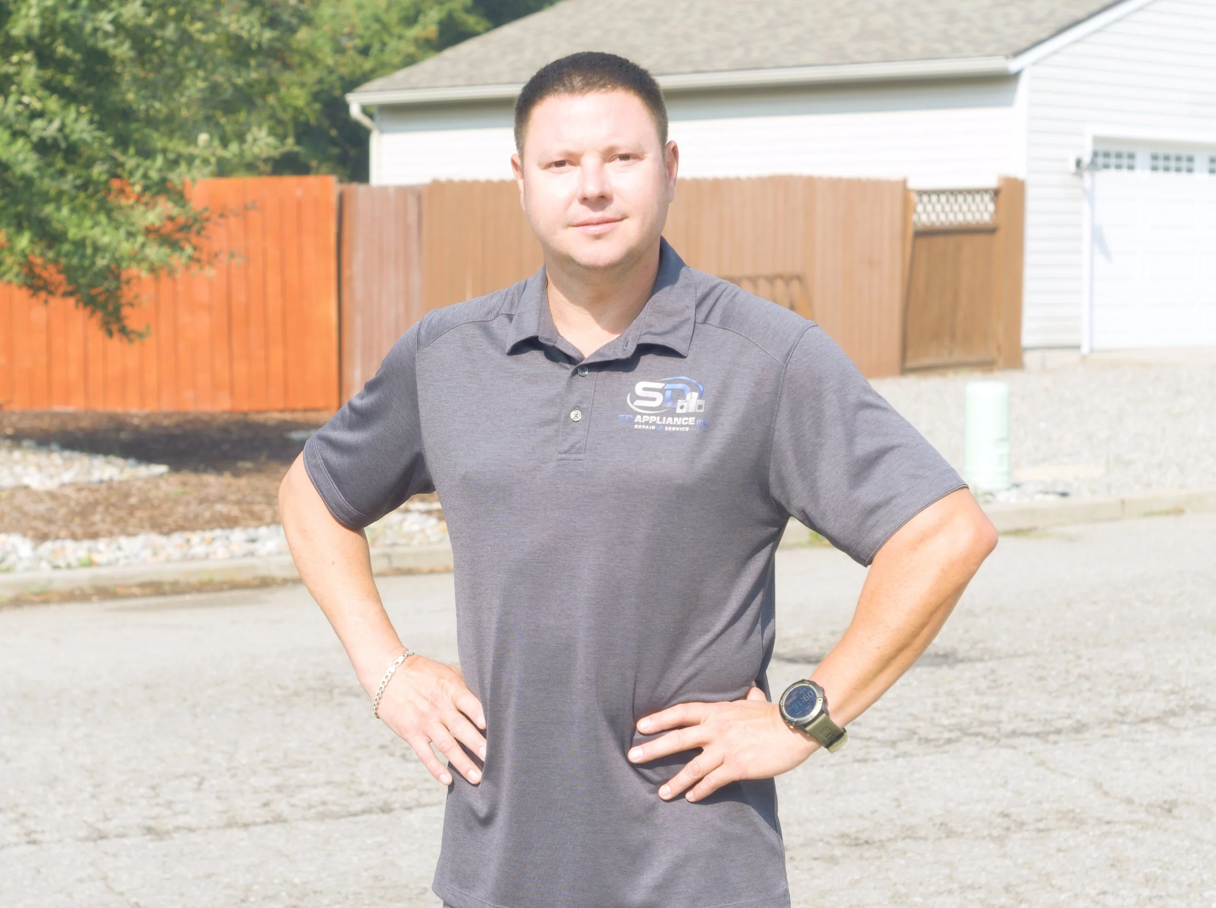SD Appliance technician standing in a driveway, ready for residential refrigerator repair in Coeur d'Alene homes
