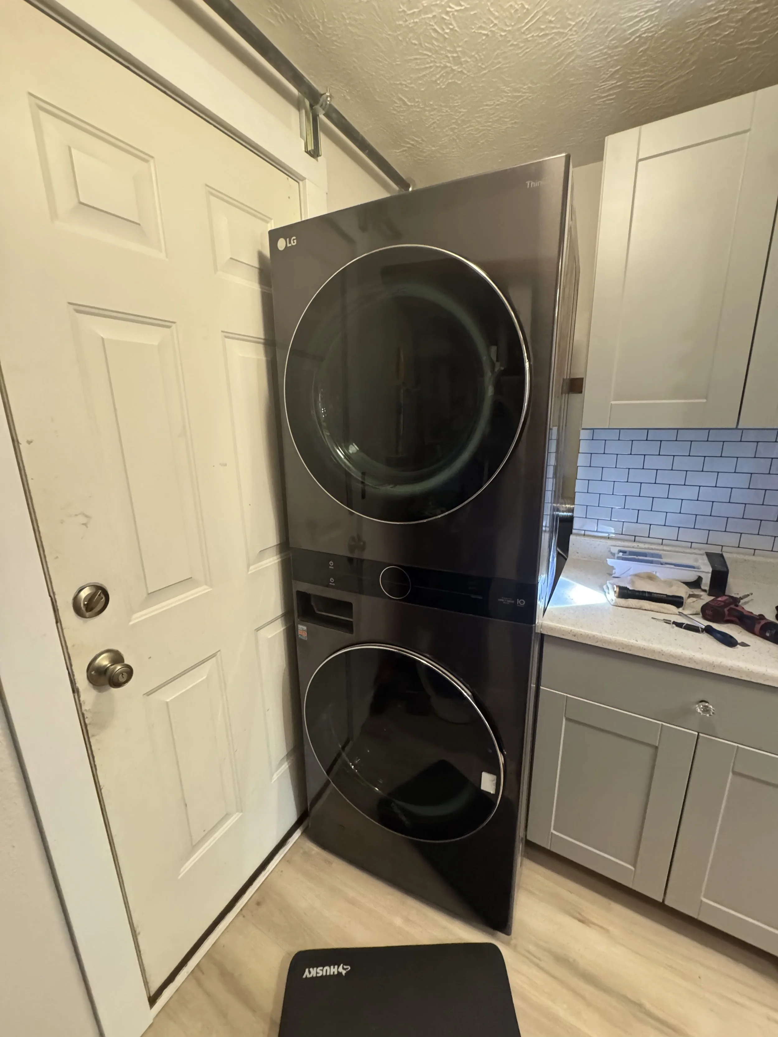 Stacked washer and dryer in a laundry closet