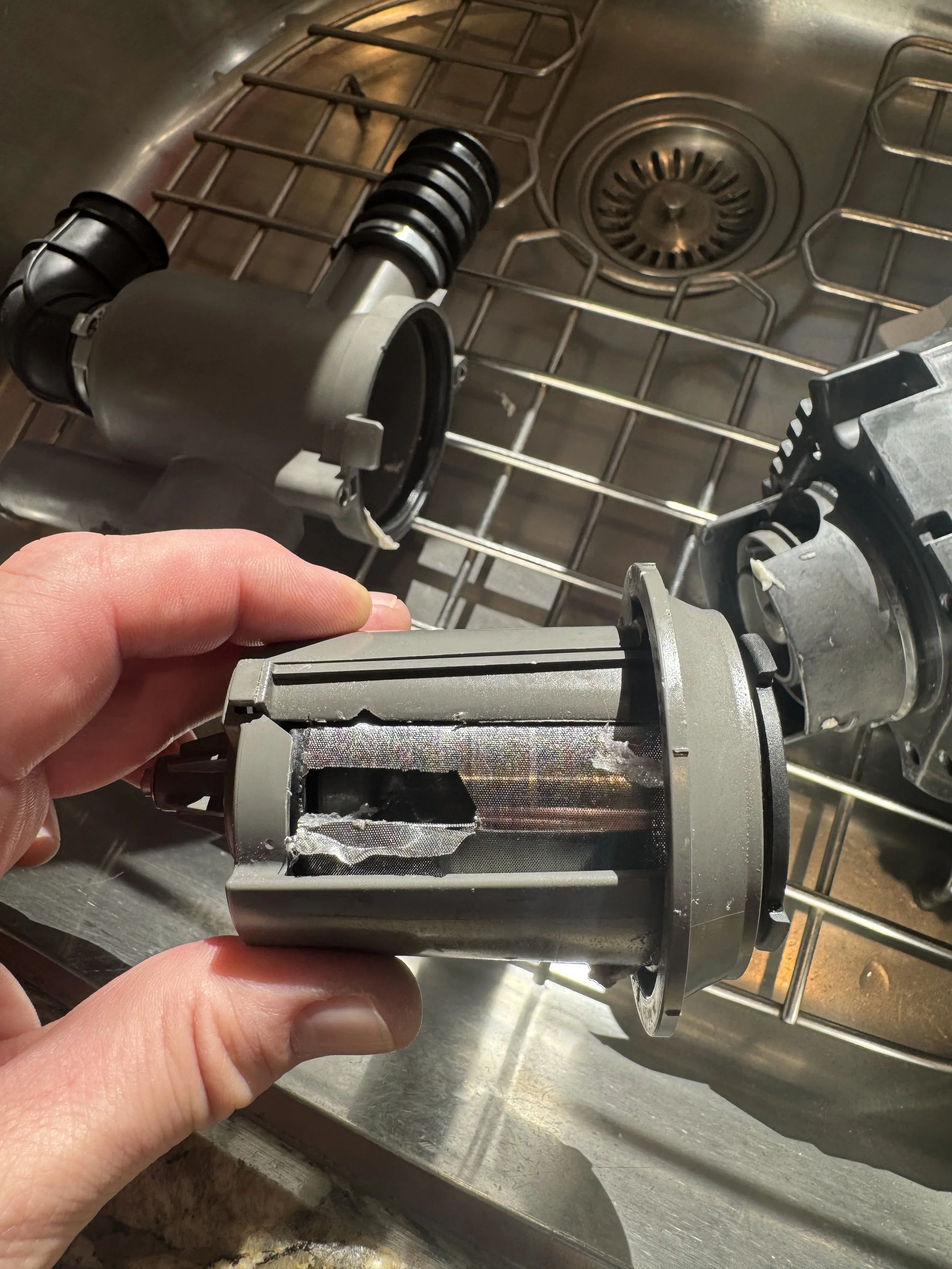 A dishwasher pump being replaced