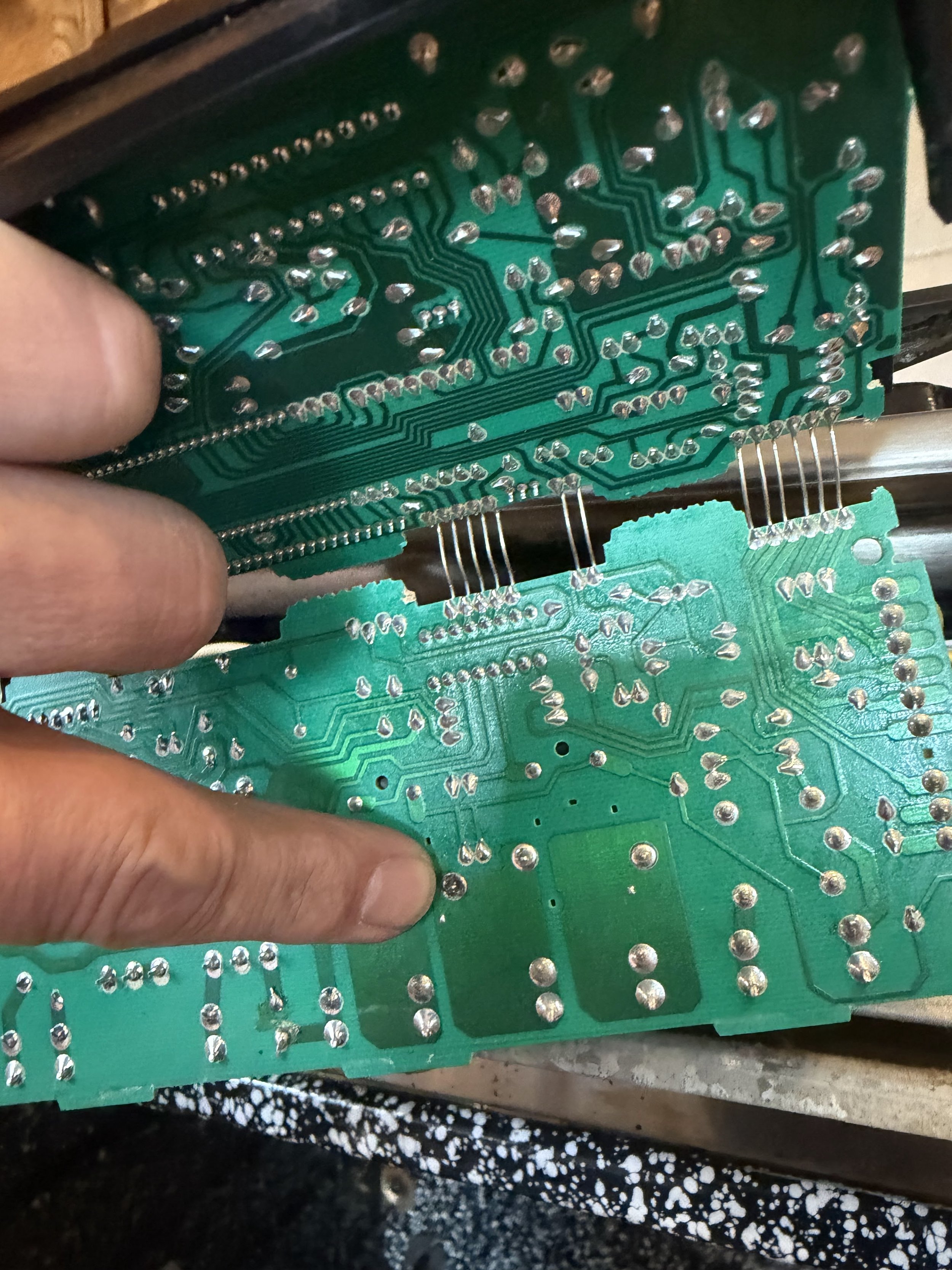 Control board being handled with a tool during a Spokane wine cooler repair by SD Appliance