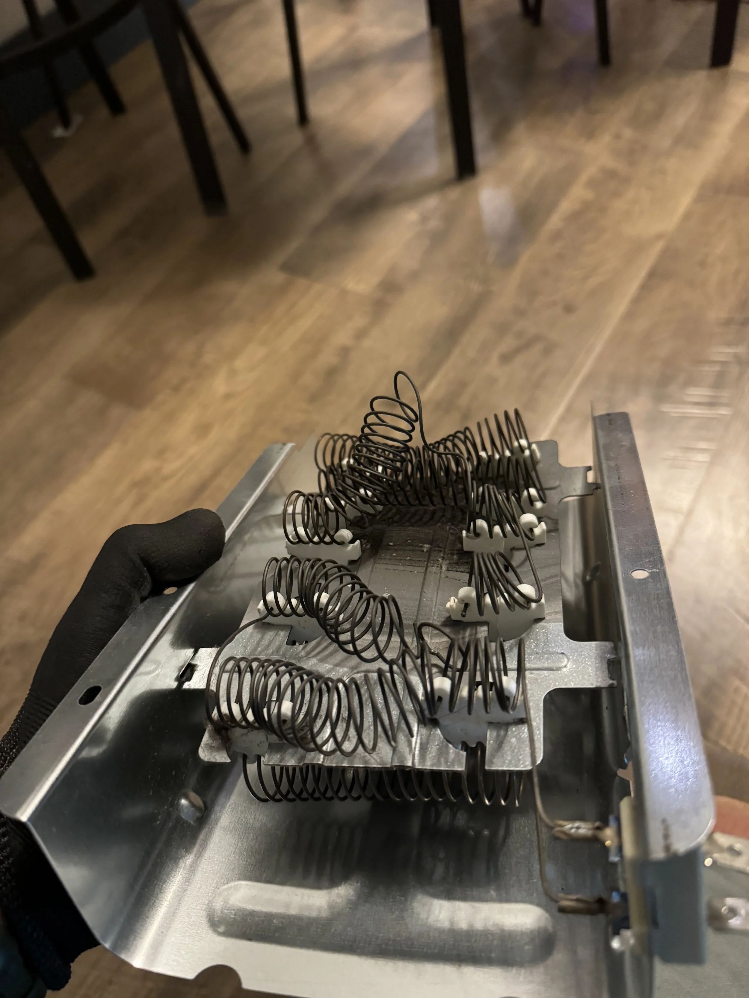 Range coil elements laid on a counter during range repair in Coeur d'Alene