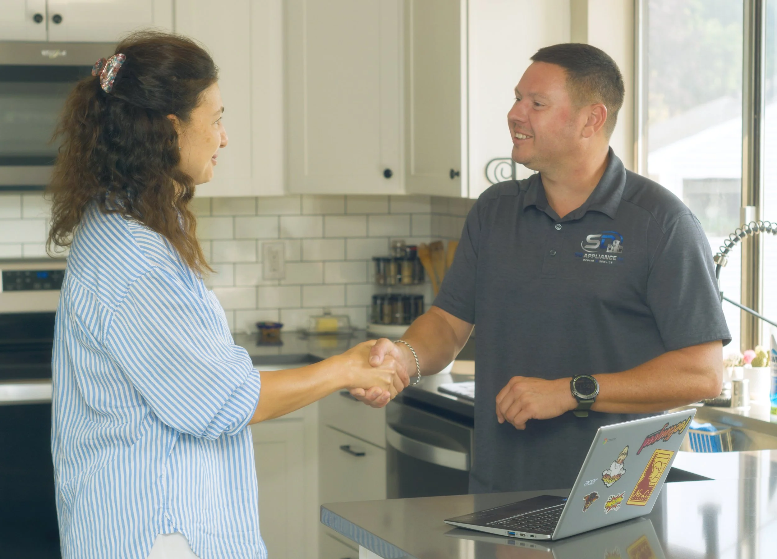 Sergei Dergunov shaking hands with a homeowner