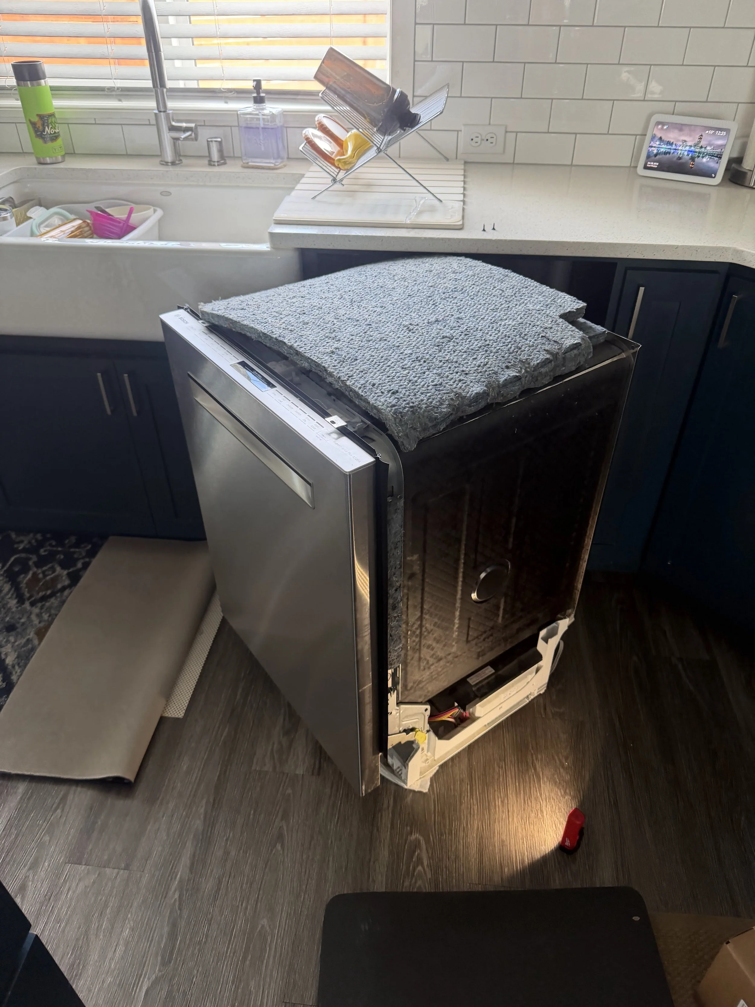 Dishwasher interior and door panel during an appliance repair in Spokane Valley by SD Appliance