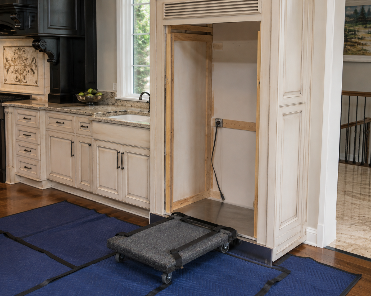 Empty cabinet opening after a trash compactor was pulled out, the space a Post Falls homeowner cleans when spills reach inside the cabinet