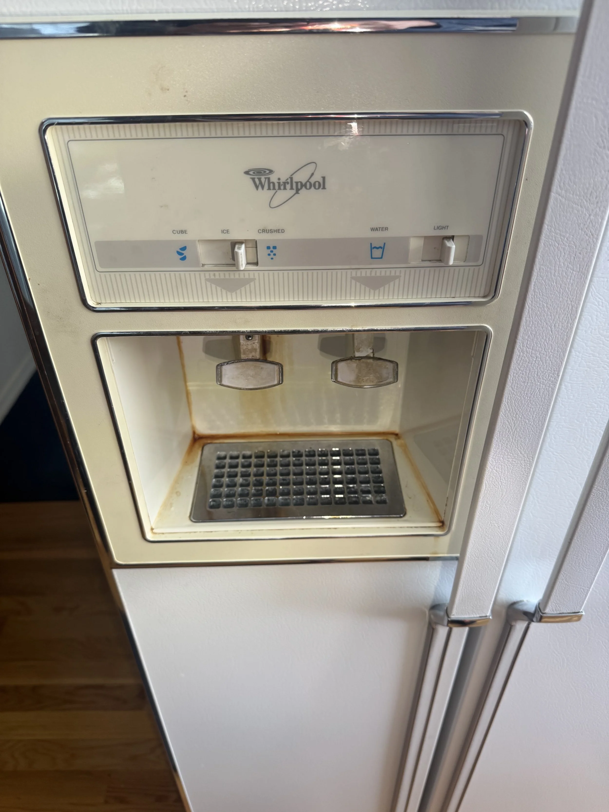 Ice and water dispenser cavity in a fridge door during a Spokane appliance repair by SD Appliance