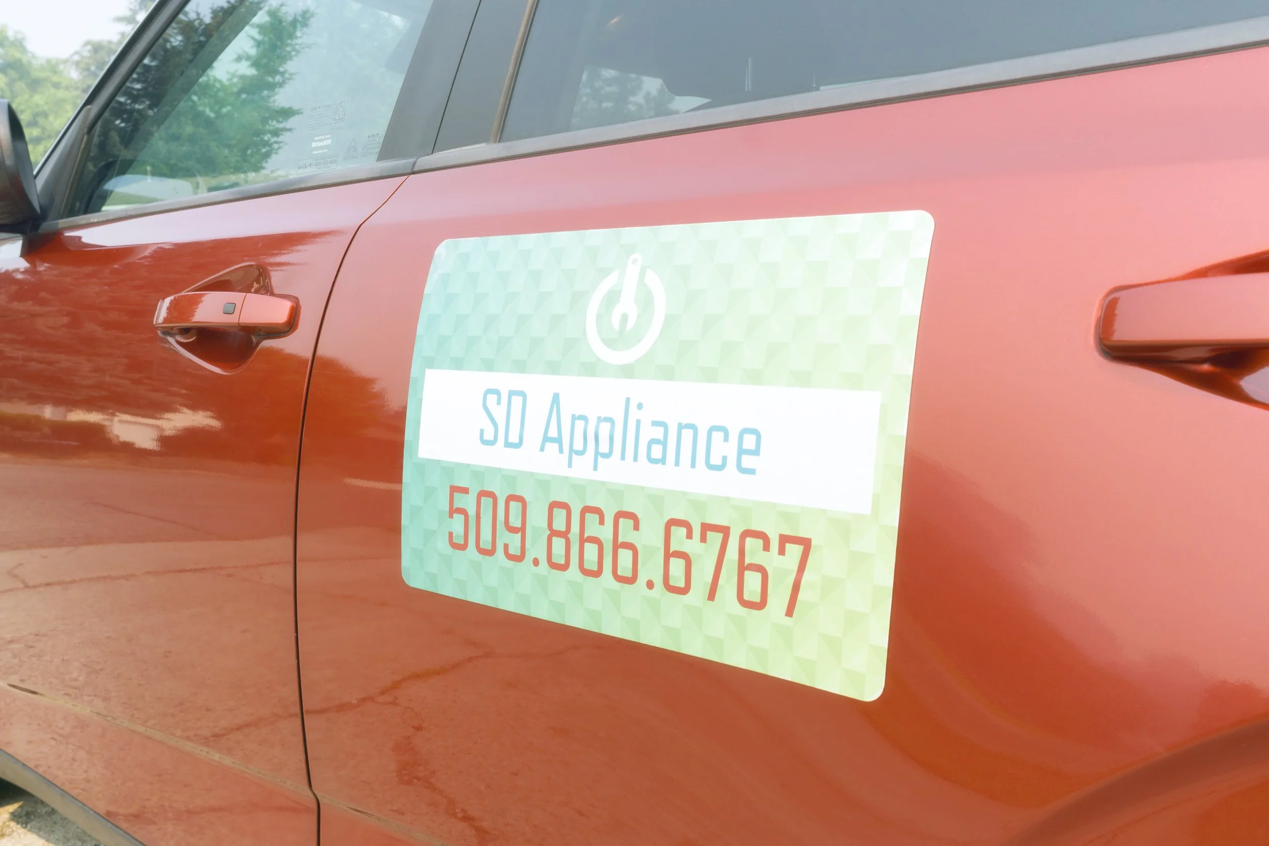 The SD Appliance magnet on the van door