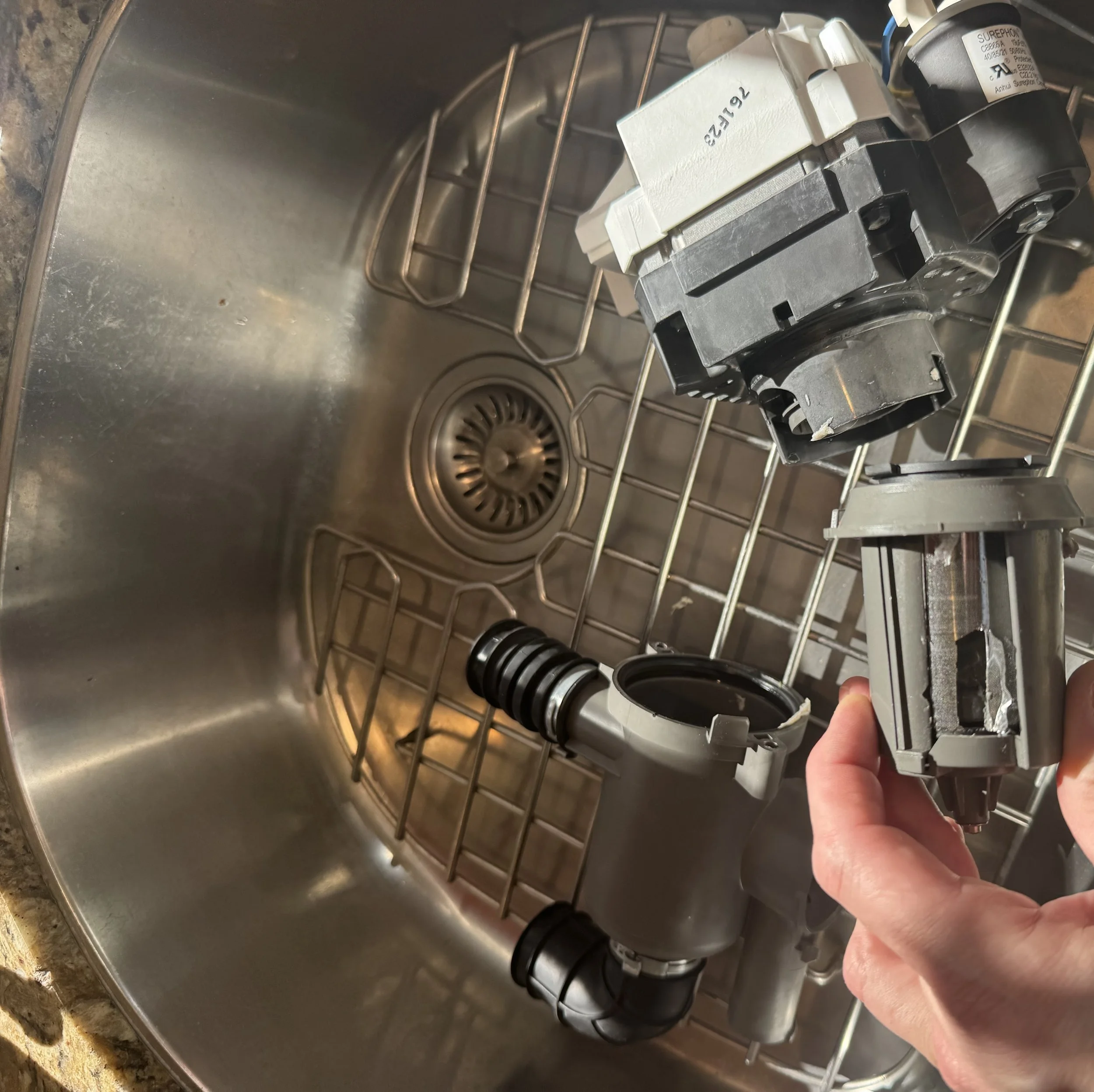 Dishwasher sump/filter, part in hand during a Spokane dishwasher repair by SD Appliance